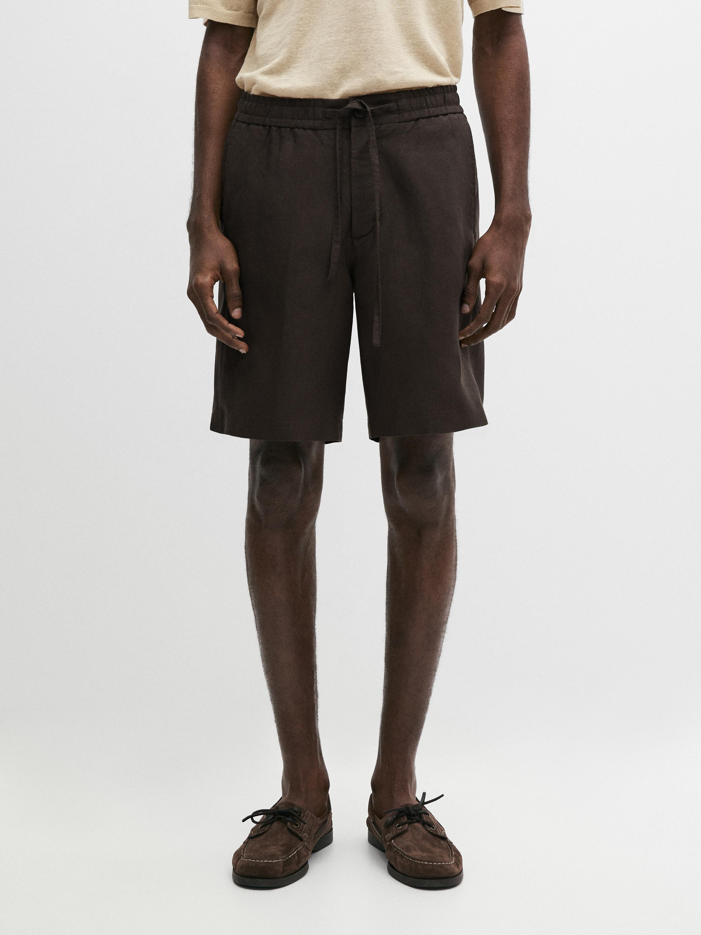 Bermuda shorts made of 100% linen. Zip and concealed button fastening. Elasticated waistband deta... | Massimo Dutti UK