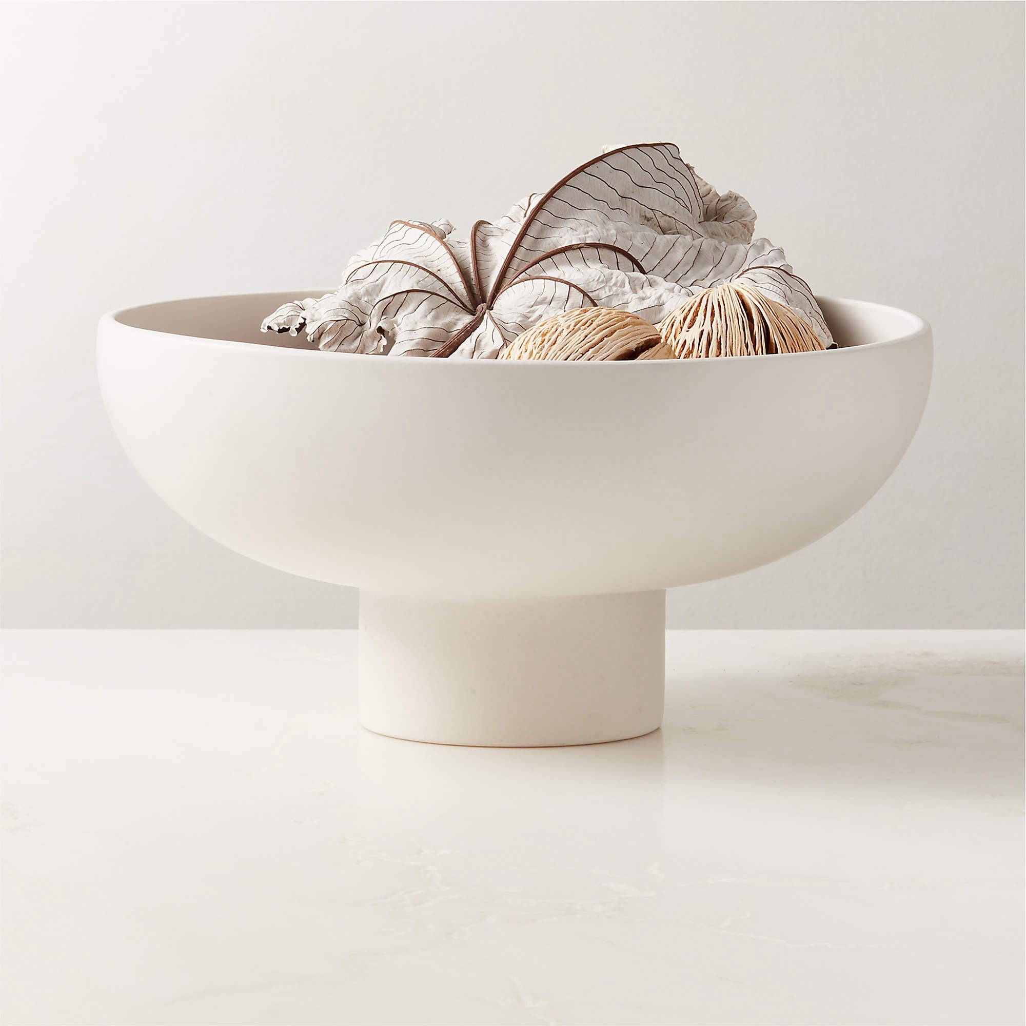 White ceramic pedestal bowl by CB2

This decorative bowl is perfect for a coffee table, console or used a centerpiece.

#LTKHome #LTKNYFW #LTKU