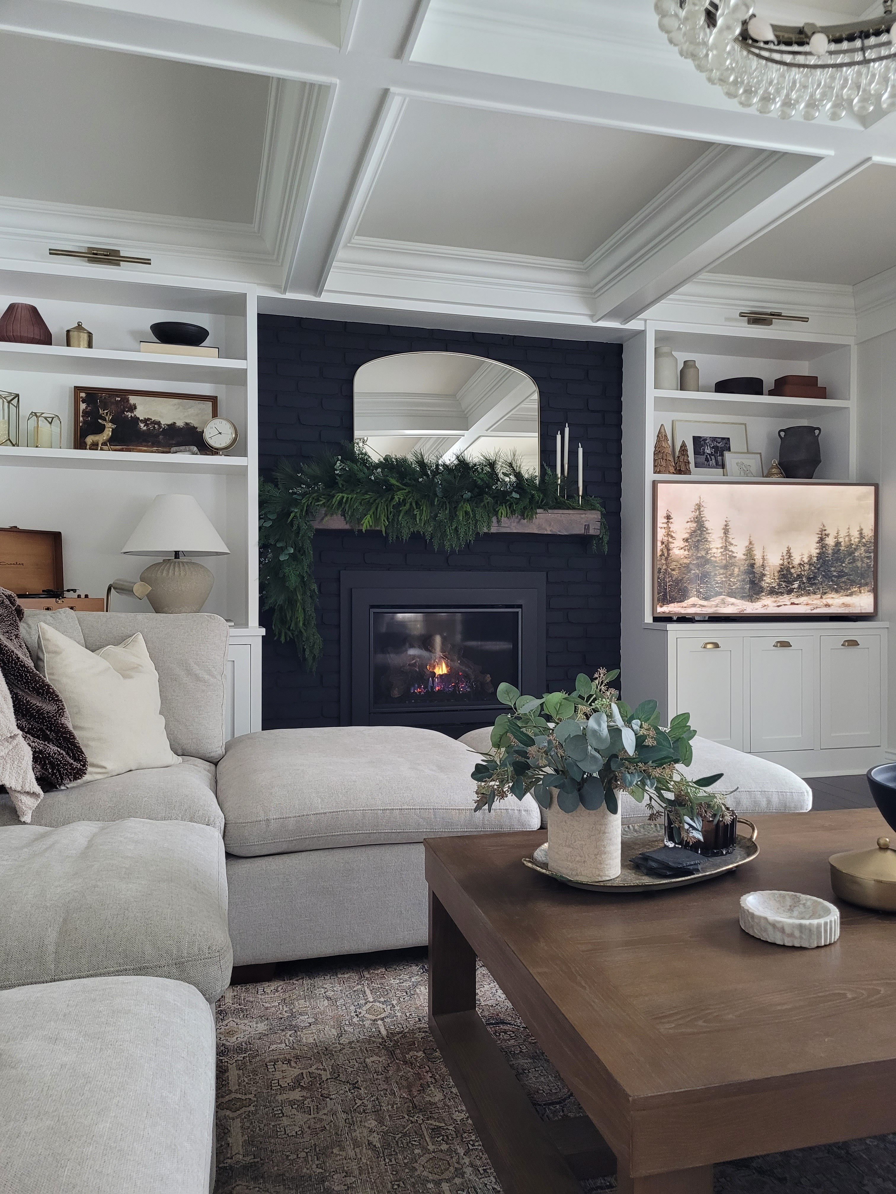 Holiday family room Christmas decor with the best affordable coffee table, mantle decor, garland, built in styling, coffee table styling, sectional sofa, gallery light, mantle mirror, arch mirror

#LTKHoliday #LTKHome #LTKCyberWeek