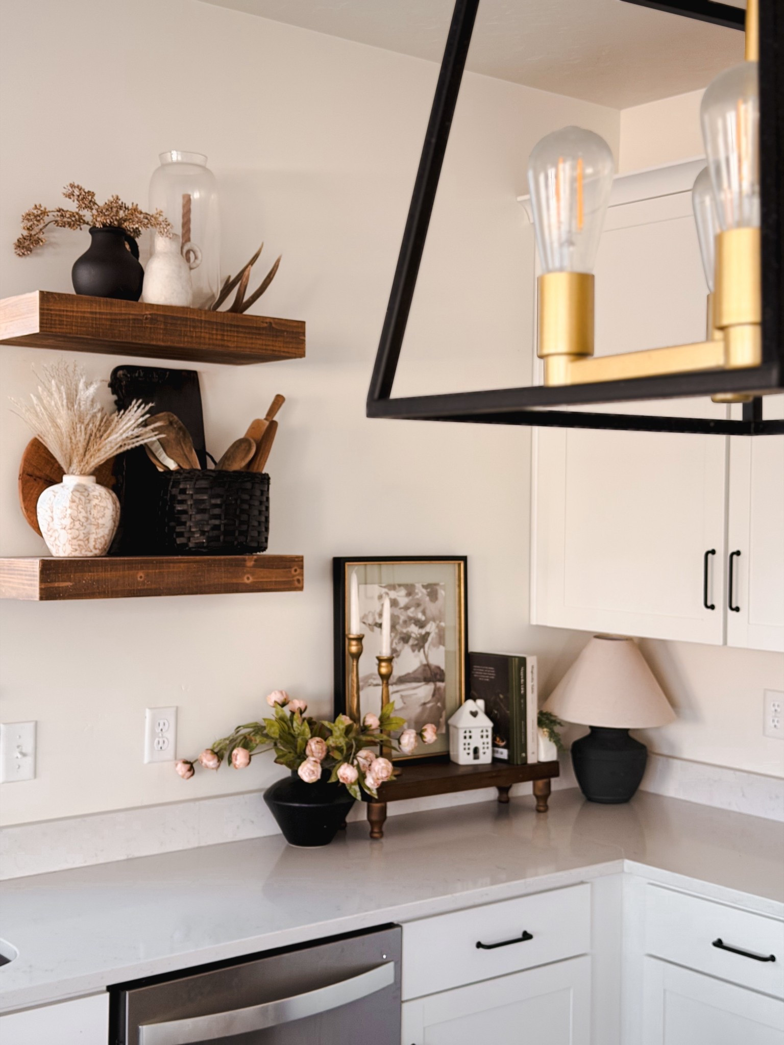 Modern organic kitchen styling 🤍
I’m obsessed with this cozy corner—layered neutrals, warm wood tones, and soft vintage details that make a space feel lived-in but still elevated. Open shelving styled with ceramic vases, natural textures, muted florals, and timeless accents for that modern farmhouse / organic modern / vintage-inspired look.

This is my go-to formula for making a kitchen feel warm, intentional, and inviting without clutter ✨ Perfect if you love neutral home decor, modern rustic kitchens, and high-end cozy vibes on a budget.

#LTKSaleAlert #LTKFindsUnder50 #LTKHome
