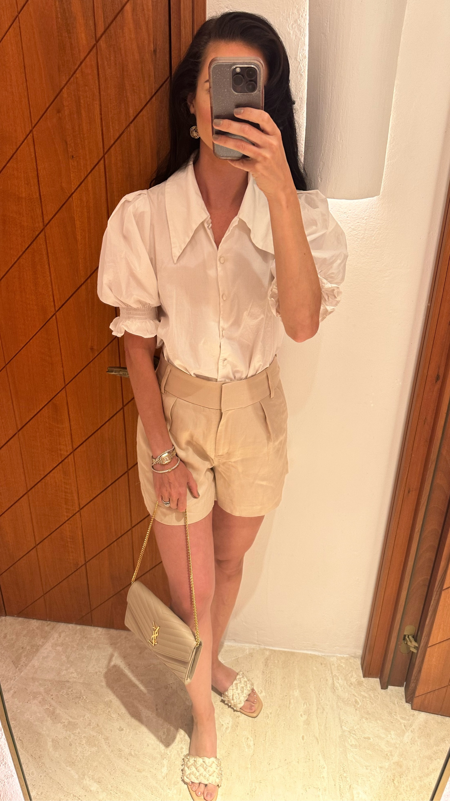 Casual vacation outfit— white button up shirt with puffed sleeves and tan linen-blend high-waisted shorts paired with tan pearl slides. I bought four pairs of these shorts in different colors because they fit so well and looked tailored. Wearing size 2 in the shorts. 

Vacation outfit. Linen shorts. High-waisted shorts. Puffed sleeve shirt. Slides. Sandals. 

Vacation 

#LTKfindsunder100 #LTKeurope #LTKtravel