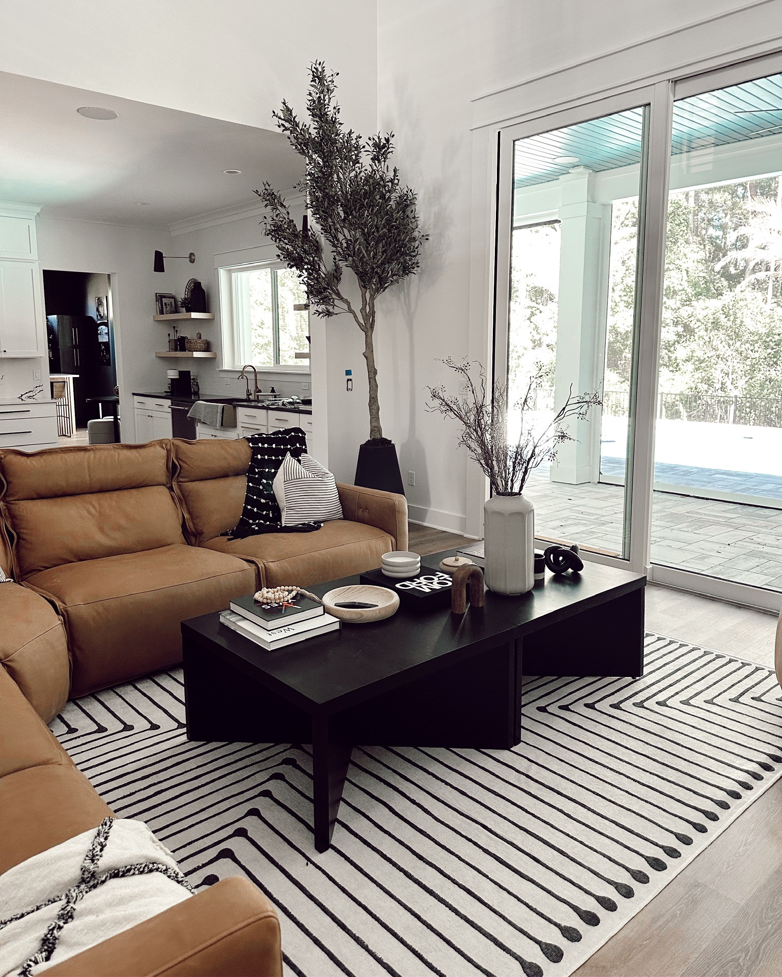 Leather sectional, rug, coffee tables, side tables, 10 foot olive tree and styling pieces in our new living room!

#LTKhome #LTKfamily #LTKstyletip