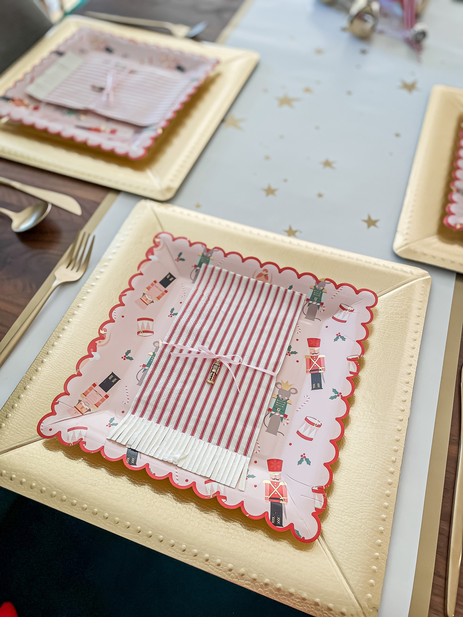 Christmas hosting tablescape with paper plates, chargers and a little charm. 

#holidaytablescape #christmastable #holidayhostjng #paperdinnerware #paperplates #nutcrackerplates #nutcracker #scallopedplates #stripednapkins #goldchargers #holidaytable #tablescape #tablesetting

#LTKHoliday #LTKSeasonal #LTKhome