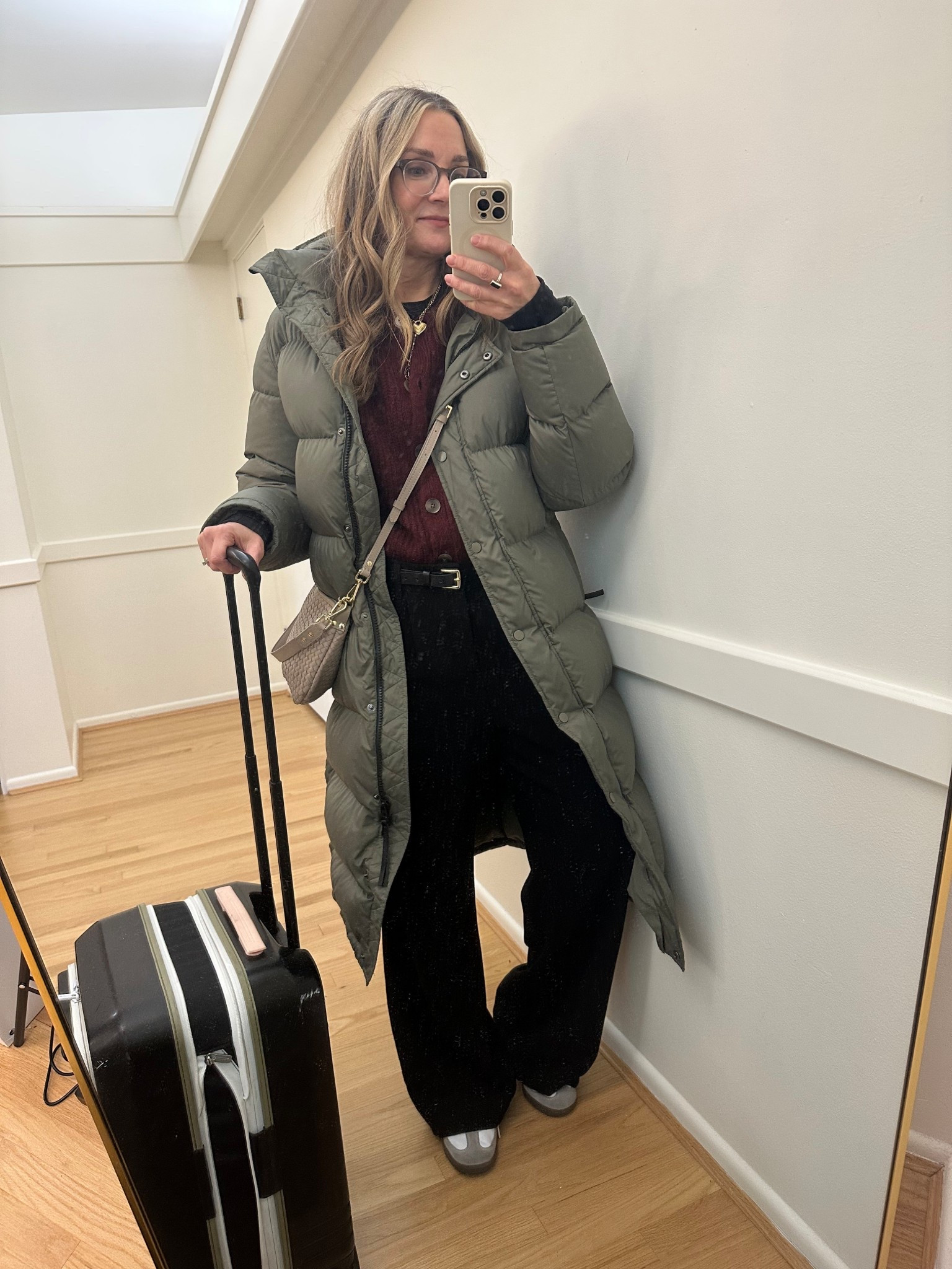 Airport outfit! Off to England to meet my new grandson! Quince long down puffer is the only coat I need: water resistant and warm! Wearing black trousers in medium , burgundy cardigan, quince crossbody in small and Adidas Sambas

#LTKOver40 #LTKTravel #LTKootd