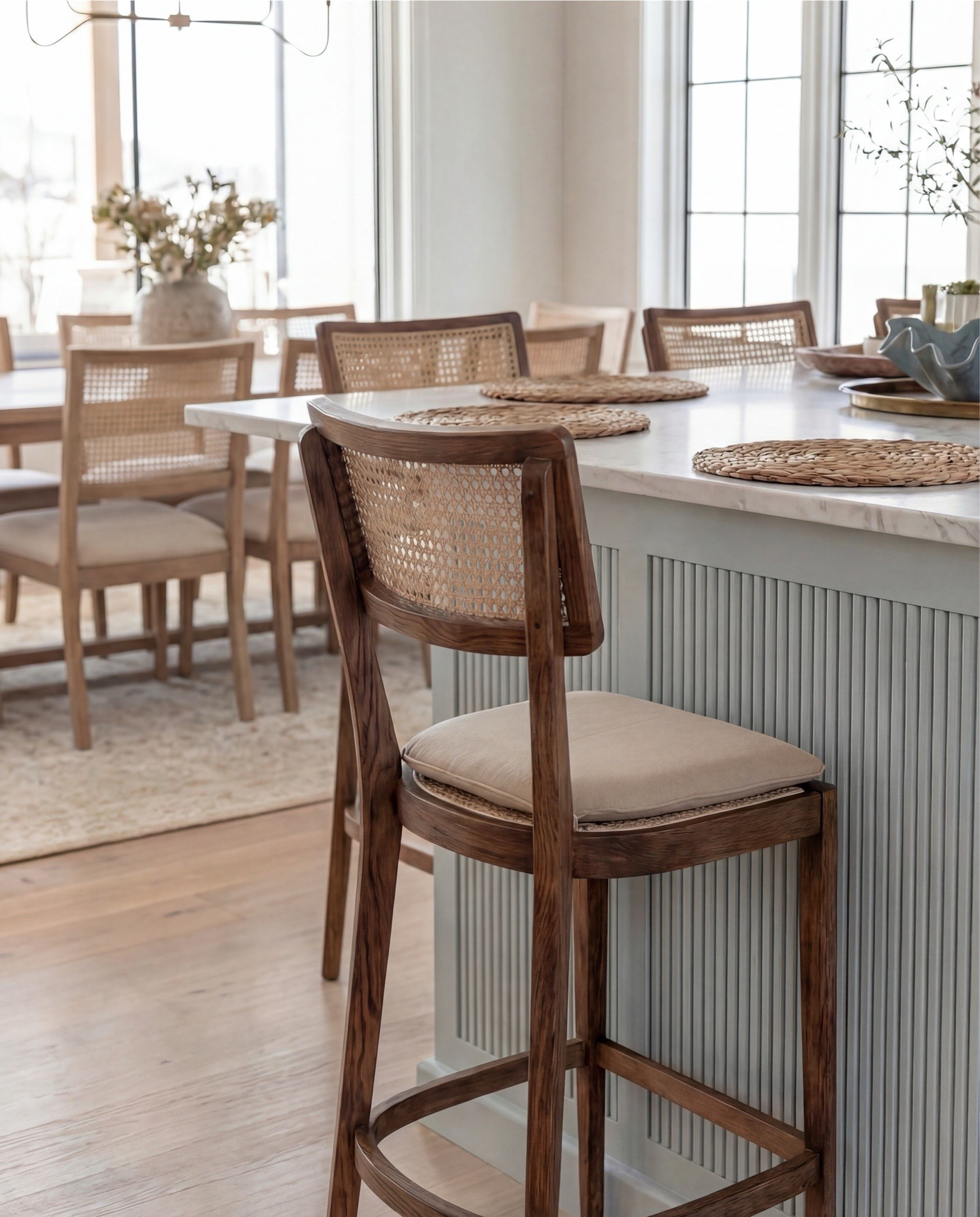 Shop the Look:
• Light natural wood kitchen cabinetry
• Soft blue fluted kitchen island
• White marble countertop (waterfall-style island top)
• Brass gooseneck kitchen faucet
• White dome pendant lights with brass details
• Cane-back counter stools with wood frames
• Matte black range and oven with brass hardware
• Pale blue tile backsplash
• Vintage-inspired runner rug (blue/neutral tones)
• Ceramic decorative vase (charcoal or earthy tone)
• Faux or dried olive branches / greenery
• Sculptural blue ceramic bowl
• Brass candle holders with taper candles
• White round pedestal tray (beaded edge style)
• Wood cutting boards (layered for display)
• Brass decorative tray

#LTKSaleAlert #LTKHome