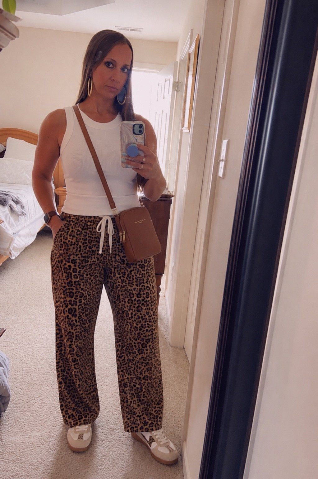 POV: You found the outfit that looks put together without trying too hard 🤎✨

These cute leopard pants + sleek white tank is giving comfy, chic, and everyday wearable. Paired with the cutest sneakers, statement earrings, and crossbody bag for the perfect effortless look. 🐆👟

If you’ve been wanting an easy outfit that still turns heads… this is it. 🙌

Comment “LINK” and I’ll send you all the details! 🛍️

#LTKOver40 #LTKmomlife #LTKootd