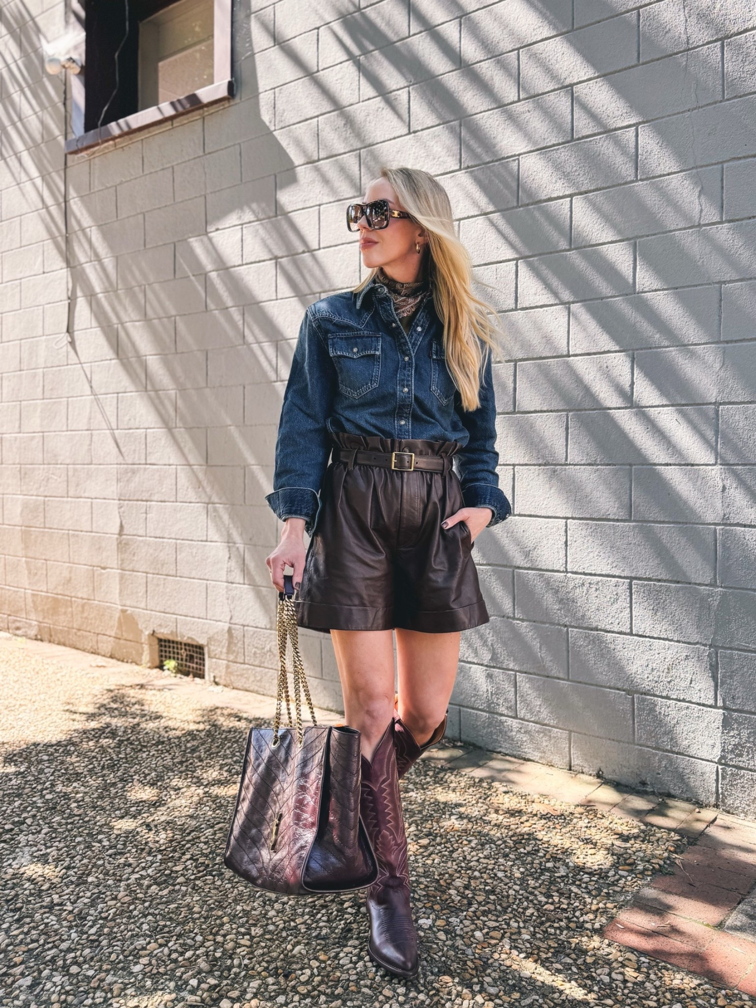 Western style fall outfit with denim shirt, paisley bandana scarf, leather shorts, burgundy cowboy boots @Tecovas

#LTKSeasonal #LTKOver40