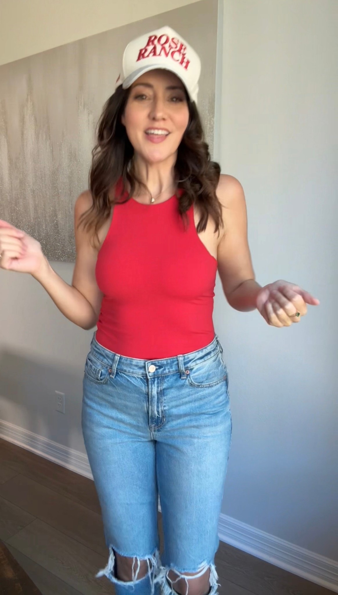 All red everything. Red tank, hat, shoes with ripped jeanss