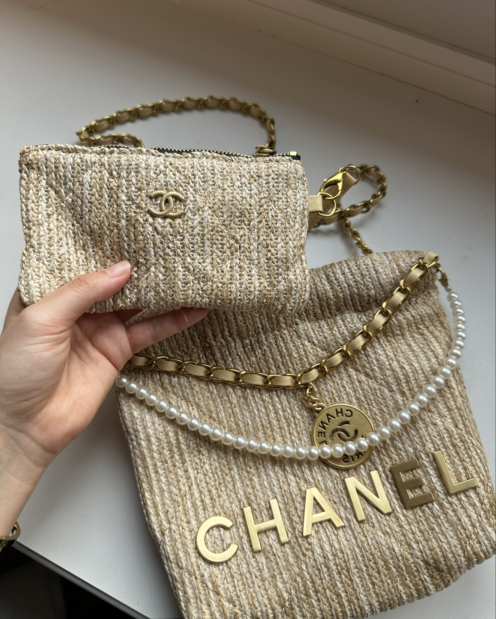Raffia Chanel 22 bag with coin purse. I got the smaller size and it’s gorgeous. Comes with dust bag and detachable coin purse. Pearl strings are also detachable  

#LTKbag #LTKfestival #LTKsummer