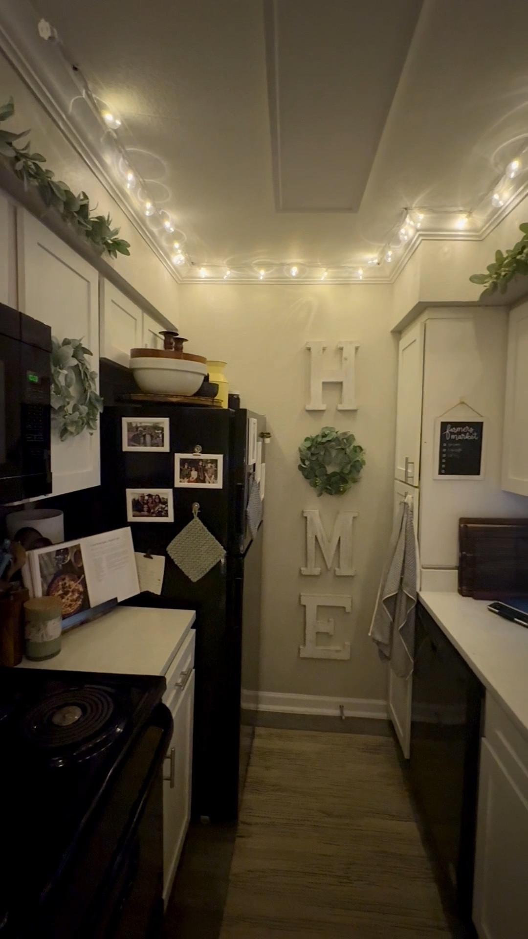 Kitchen glow-up, but make it cozy.
Soft light strands tucked along the ceiling, simple wreaths on the cabinets, and a leafy garland that makes the whole kitchen feel warm before the oven even turns on. This is one of those small decor moments that changes how the room feels, especially in the evenings when dinner is simmering and the day finally slows down.

The lights, wreaths, and garland are easy to layer, renter-friendly, and simple to take down. Cozy does not have to mean complicated.

#LTKfoodie #LTKFindsUnder50 #LTKHome