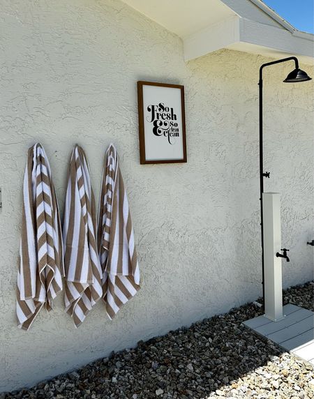 Outdoor shower with towels and towel hooks! Since this is a lake house, I used boat cleats. 

#LTKSeasonal #LTKhome #LTKstyletip