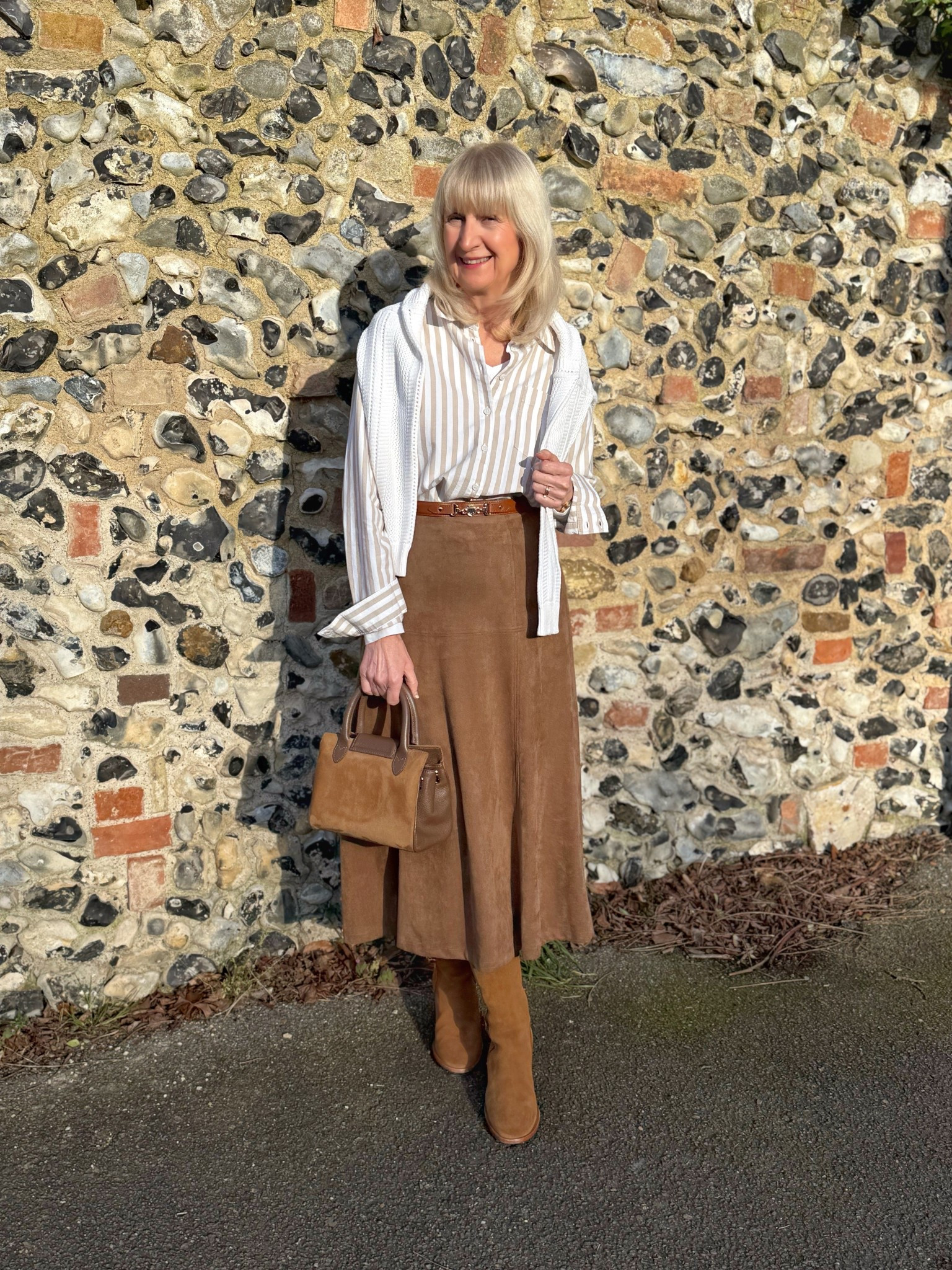 Brown faux suede midi skirt with cotton oversized brown pin stripe shirt, tan boots and bag. 

#LTKFashionMonth #LTKuk #LTKspring