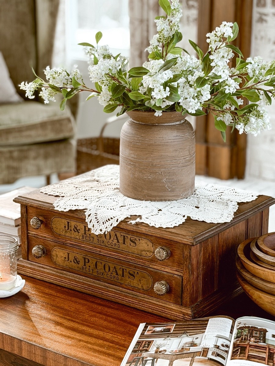 I recently came across this J. & P. Coats spool box. I added it to our coffee table for a layered look with hidden storage for remotes. 

#LTKHome