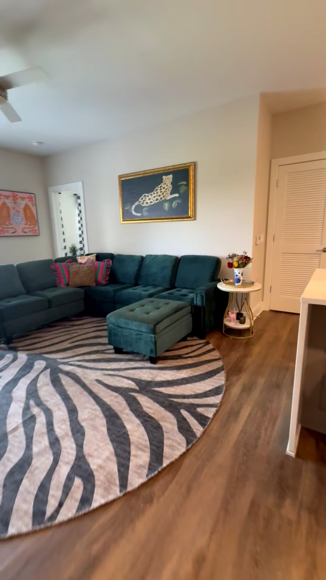 🐆🐆 Next stop on the tour of my new apartment: the living room. I wanted to create a space that felt chic and fun all at the same time.  The emerald velvet couch is the star of the show. It's so luxurious and comfortable.  Gotta have funky art prints and lots of throw pillows.
 
 #LTKhome #LTKstyletip #LTKapartmenttour #apartmentdecor #livingroominspo #chicdecor #fancylivingroom #golddecor #velvetcouch #emeralddecor #apartmenttherapy #cozyliving #homeinspo #decoratingideas #interiordesign #glamdecor #funkydecor 