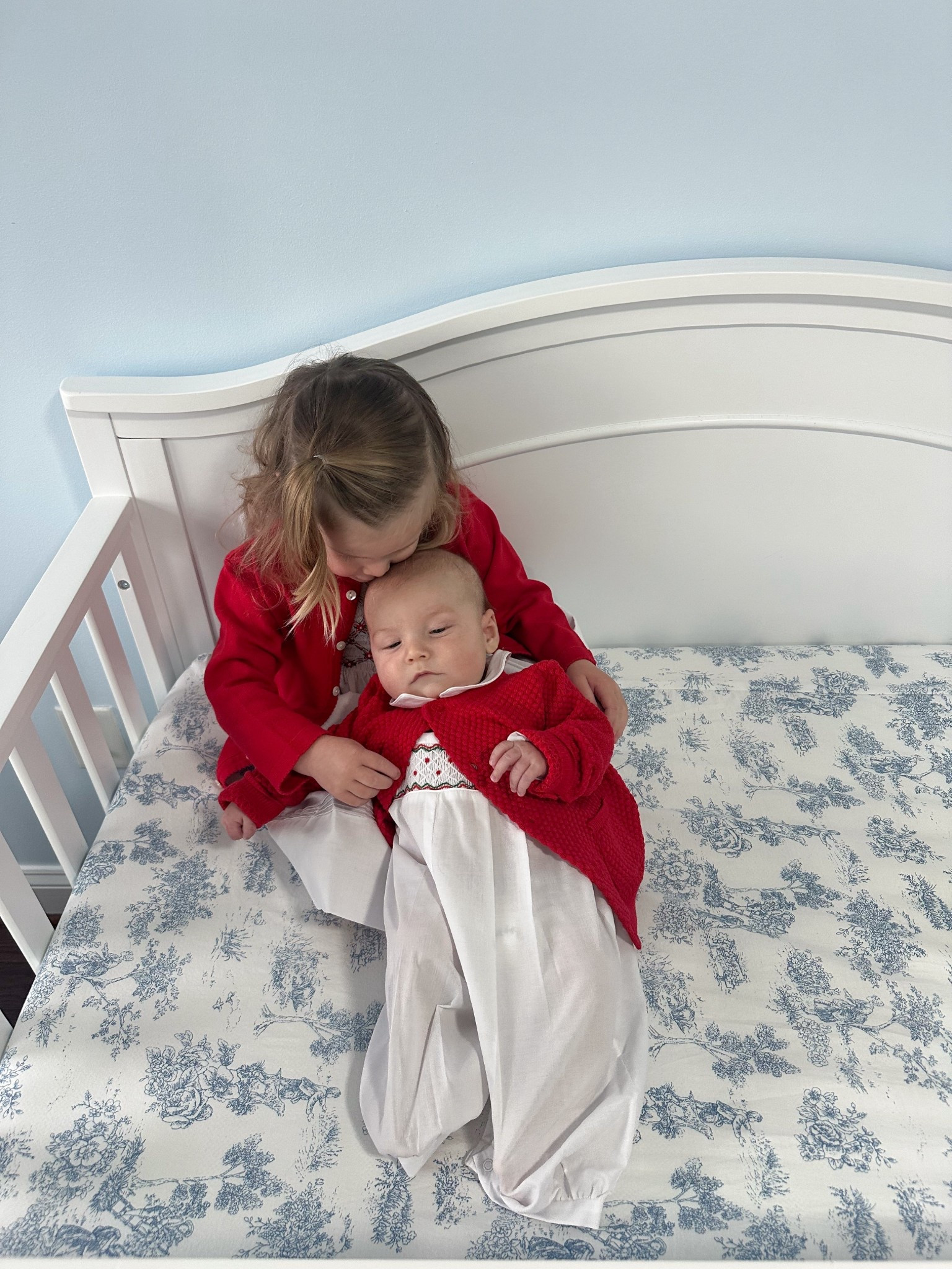 Matching toddler baby Christmas outfits / Tatum is in the 2T dress and 3T cardigan. Beckham is in the 3m outfit and 6m cardigann