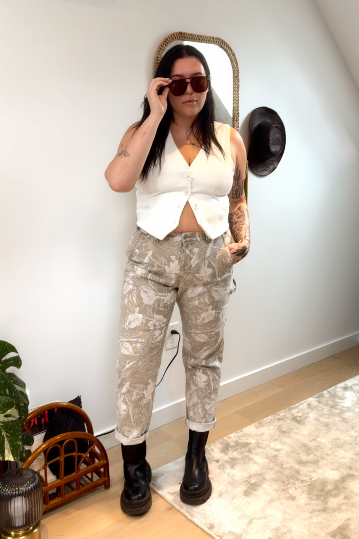 Explore bold and confident masc lesbian style with this striking outfit! 🌟 Featuring Abercrombie men’s camo pants paired with a sleek white vest, sturdy combat boots, and stylish sunglasses. Perfect for anyone looking for lesbian fashion inspiration or midsize outfit ideas (size 14-16). Dive into a world where fashion meets identity! #LesbianStyle #MascFashion #MidsizeFashion #Size14Fashion #CombatBootsStyle #SunglassesLook #VestOutfit #CamoPants