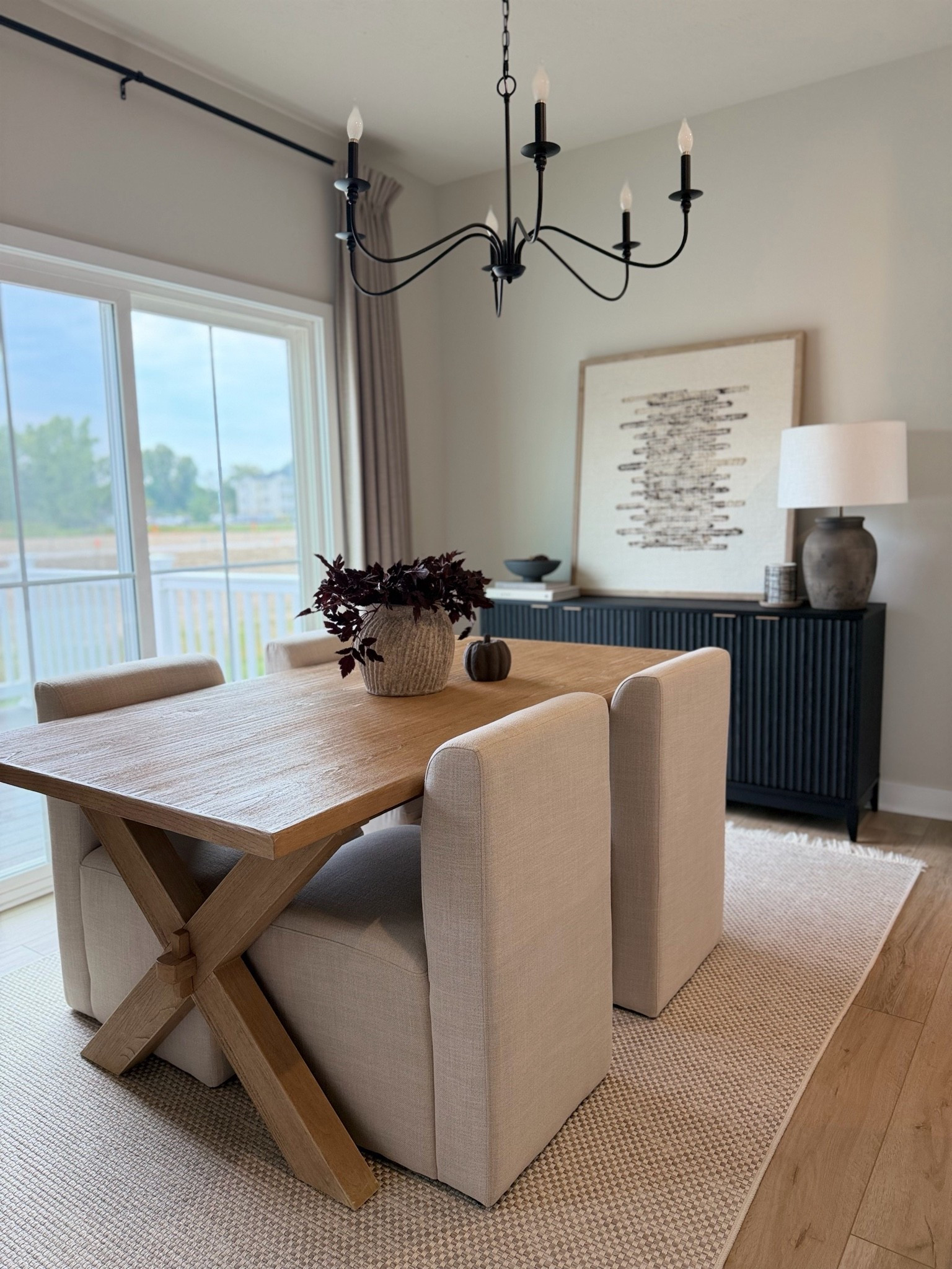 Dining room, dining table, dining room table, black sideboard, black console, fluted console, upholstered chairs, leaning art, black chandelier, concrete vase, plum stems, fall stems, brown lamp, coffee table books, area rug, neutral rug, brown pumpkin, linen curtains

#LTKSaleAlert #LTKSeasonal #LTKHome