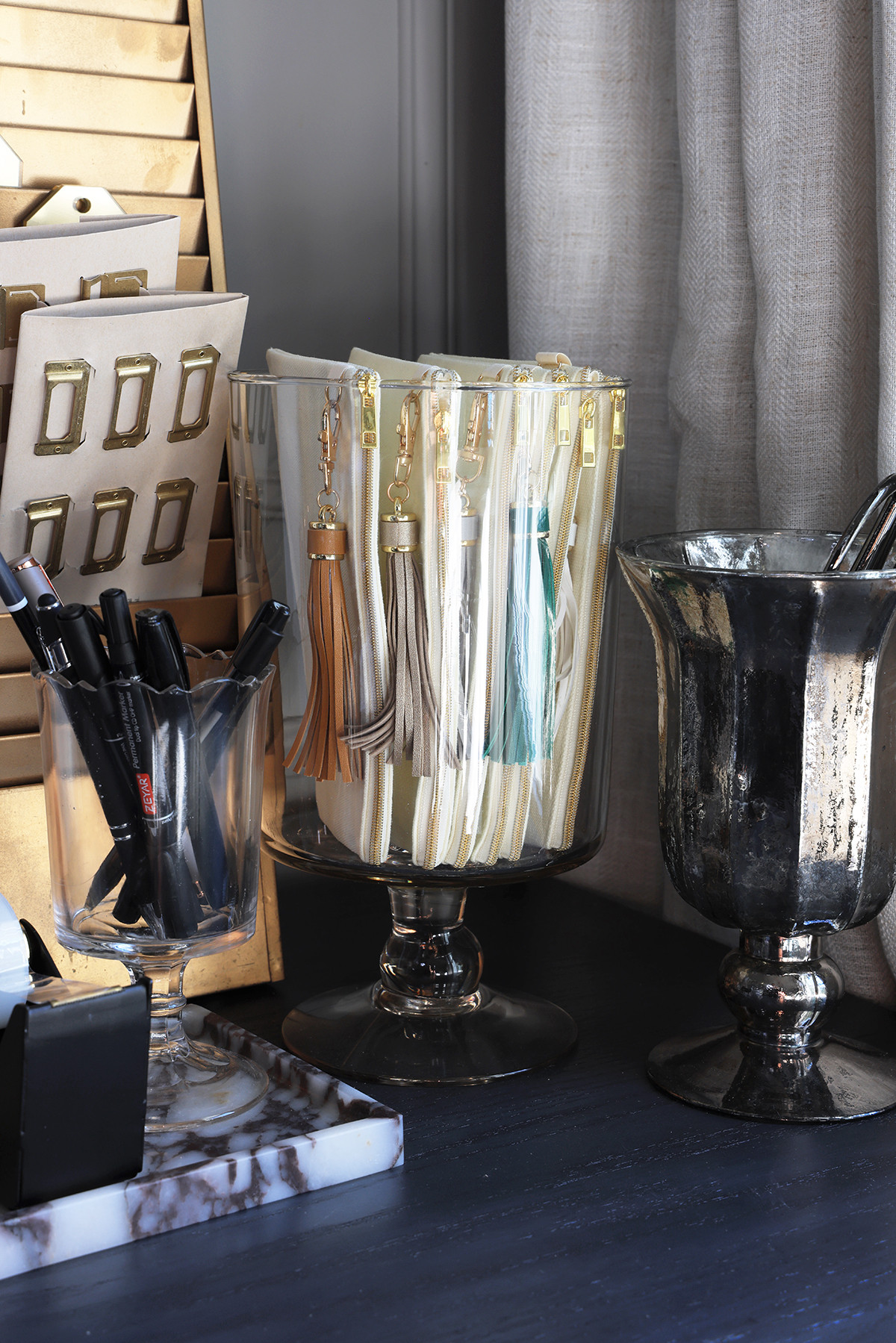 Stylish ways to organize office supplies | Small fabric bags with tassel key rings to store small items 

 #LTKHome