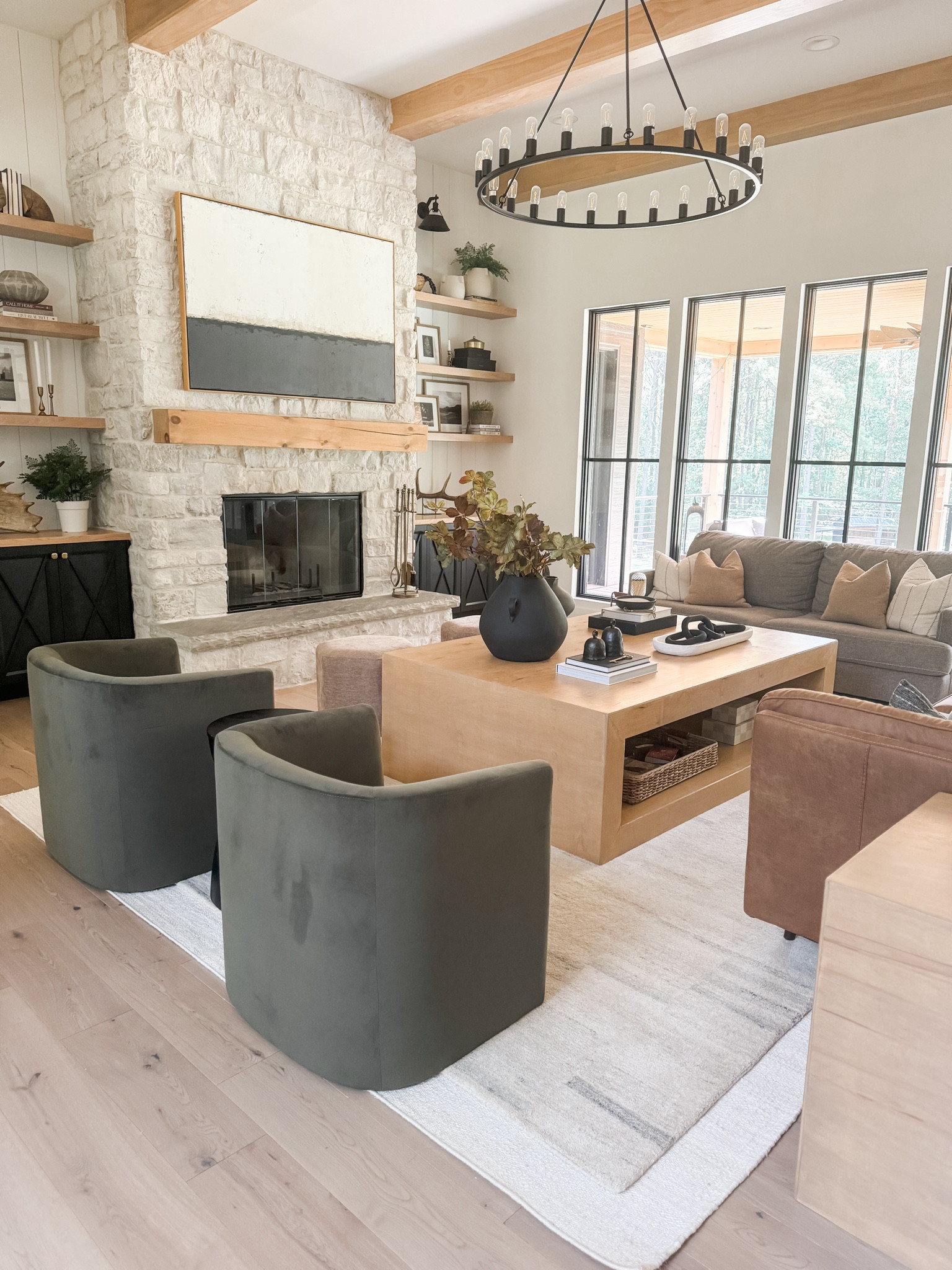 Living room refresh in preparation for fall.  Love the textures of velvet chairs, wool and jute layered rugs, new faux floral stems and coffee table books.

#LTKHome