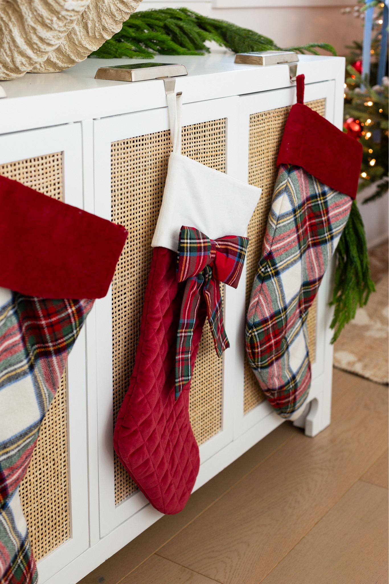 Our plaid Christmas stockings in our coastal loft with white shiplap walls decorated for Christmas. The space includes  red velvet pillow and light blue knit pillows on our linen sectional, "O Holy Night" art, real-touch Norfolk pine stems in a white terra cotta vase, picture ledge gallery wall frames, and light blue ceramic lamps. See our full Christmas home tour here: https://lifeonvirginiastreet.com/2024-christmas-home-tour/ #ltkholiday #ltkhome #ltksalealert #ltkfindsunder50 #ltkfindsunder100 #ltkstyletip #ltkseasonal 

#LTKHome #LTKSaleAlert #LTKHoliday