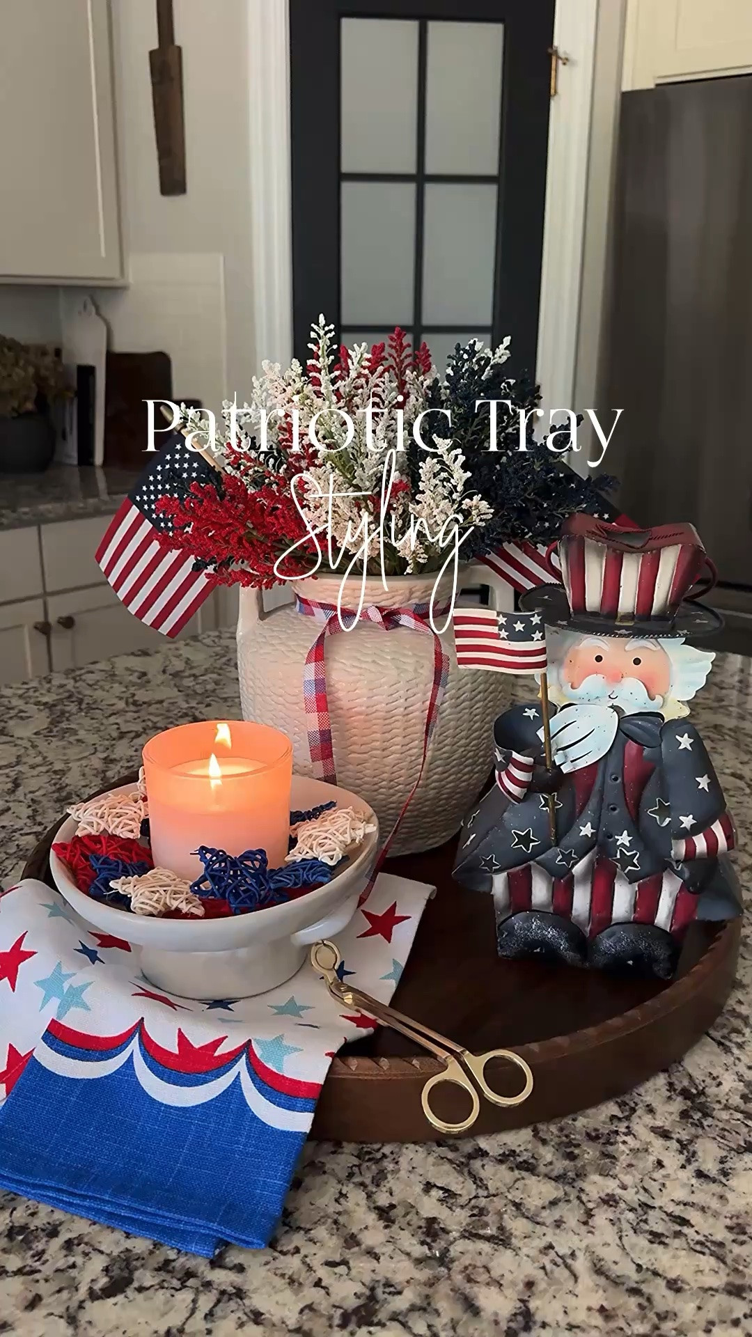 Patriotic Tray Styling!!
I think this is my favorite red, white & blue styling to date. I have sourced a few of the vintage Uncle Sam lanterns and linked them below.

Vase, red, white & blue stems, vintage metal Uncle Sam lantern, patriotic towel, bowl, red, white & blue stars, candle, gold wick trimmer, ribbon, small American flags, tray