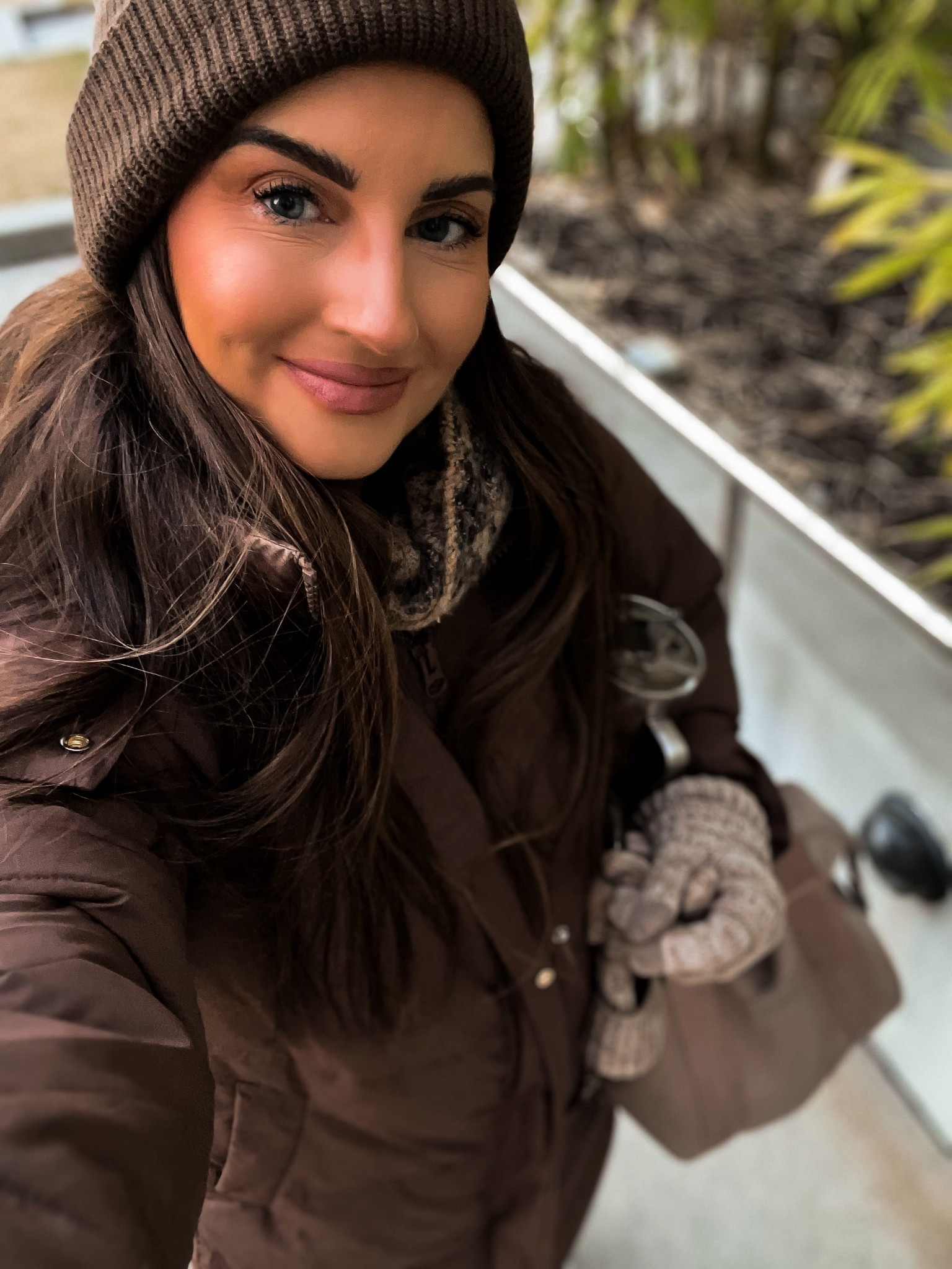 Long brown puffer winter jacket 
Brown beanie
Oatmeal brown gloves 
Taupe soft lunch box