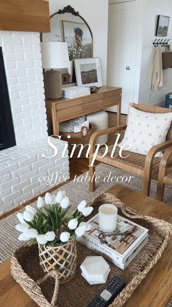 A simple coffee table decor idea with a basket, faux flowers, candle, books & coasters  

#LTKhome #LTKstyletip #LTKFind