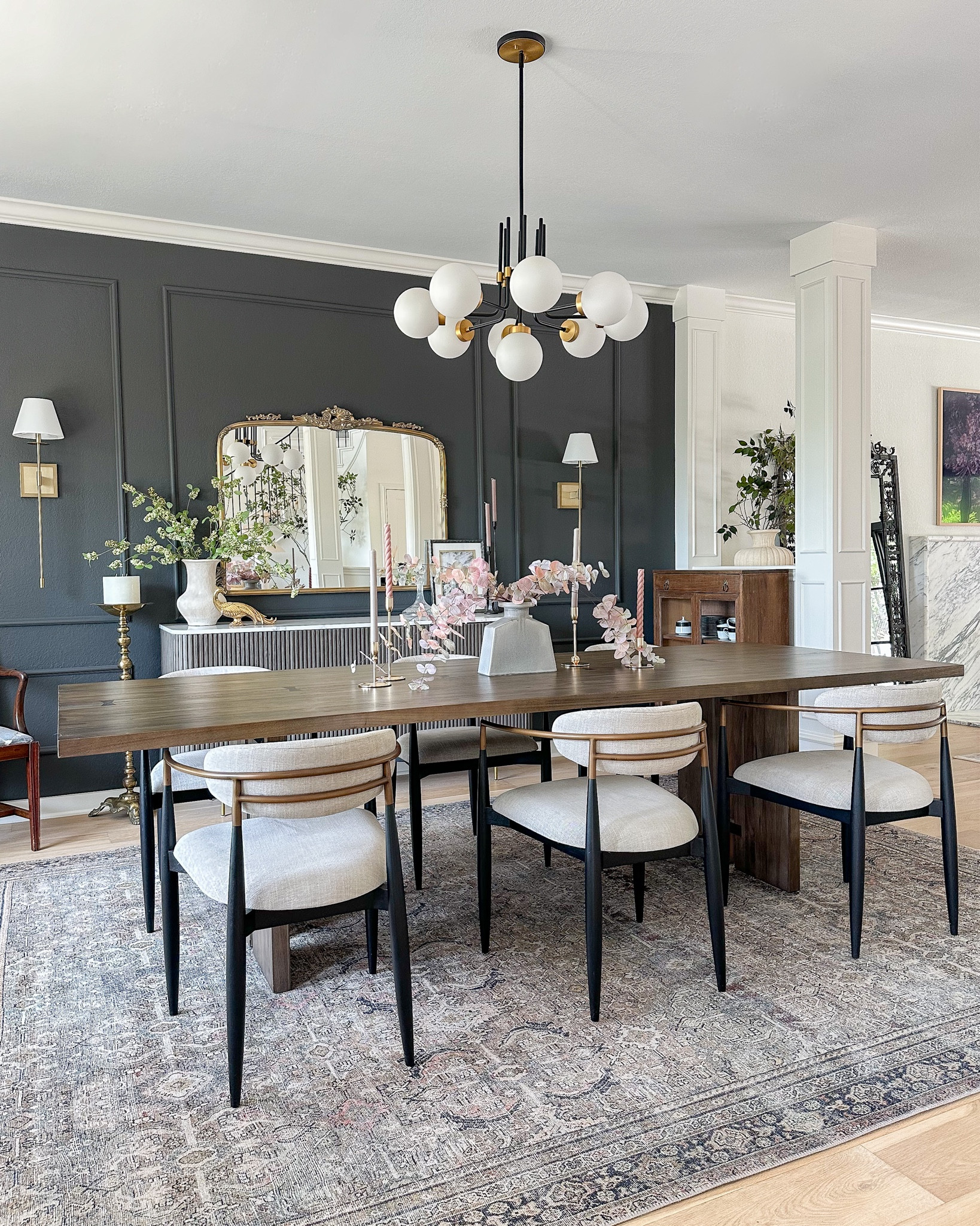 Dining room decor featuring my Loloi rug in Olive/Charcoal, Arhaus Jagger dining chairs (linked the dupe!), Crate & Barrel dining table, modern globe black and brass chandelier, sconces, ornate wall mirror, and fluted buffet.

#LTKstyletip #LTKhome #LTKsalealert