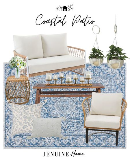 Outdoor couch. Outdoor sofa and chairs. Coastal outdoor seating. Blue coastal outdoor rug. Outdoor blue and white throw pillow. Outdoor white lumbar pillow. Coastal side table. Outdoor wood coffee table. Gold candle decor. Metal hanging pots  