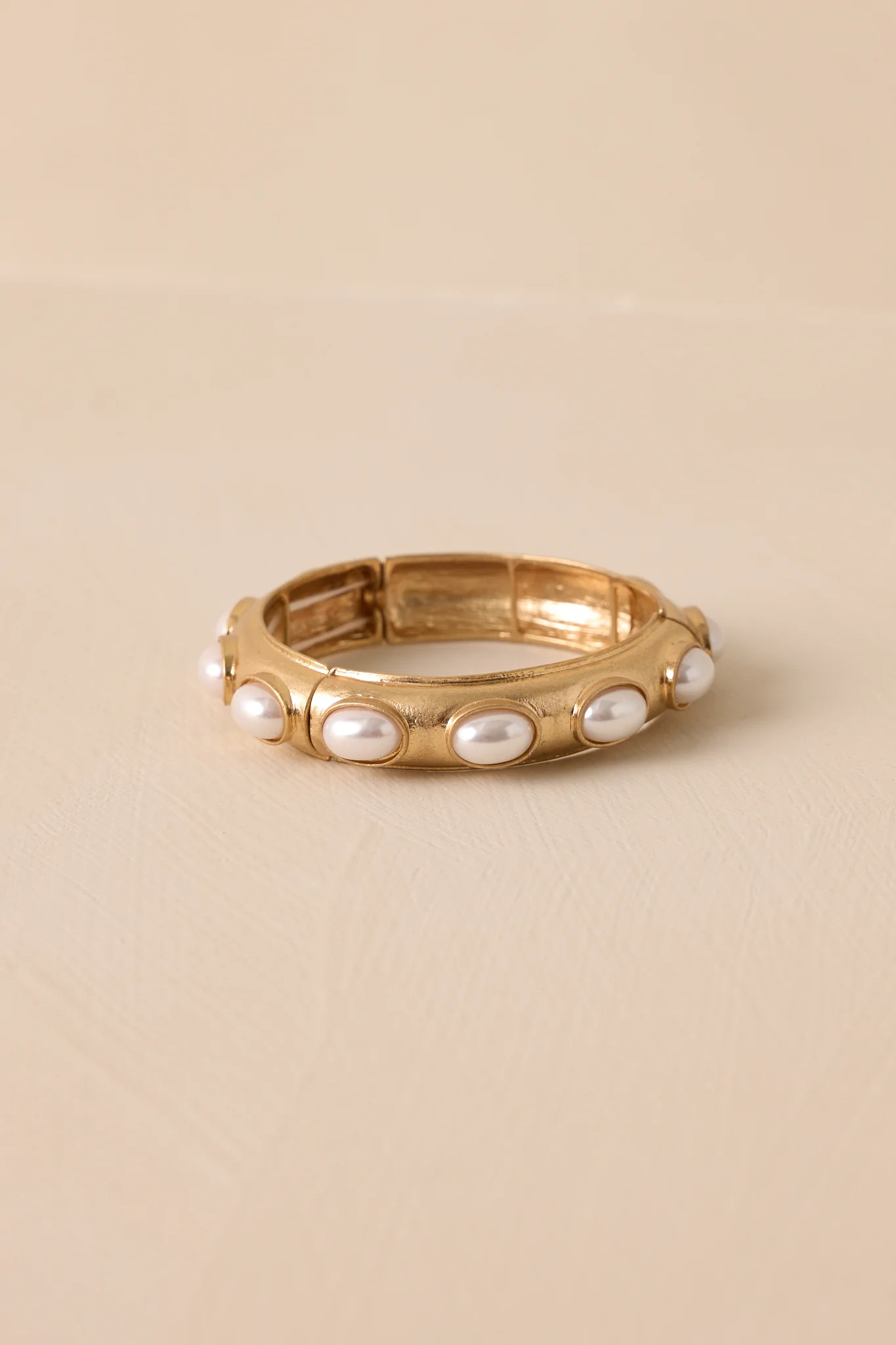Radiant Row Worn Gold Pearl Bracelet | Red Dress