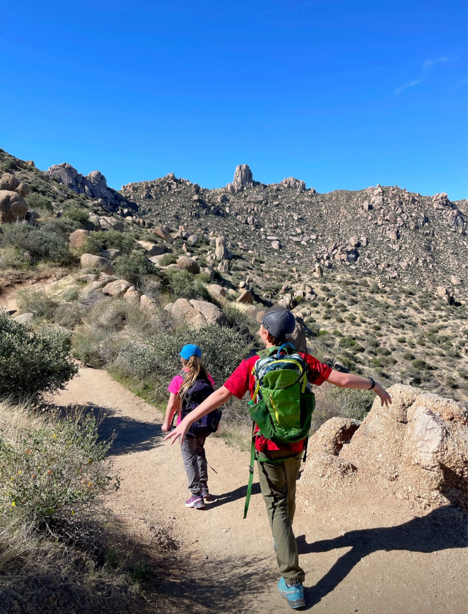 When it comes to hiking with kids, we w found the REI kids Mountainmaker pants to be the most comfortable and durable. They’re great no matter how hot it is and if it’s cold we just add a base layer. They hold up to any kind of adventure including sliding and scrambling over rocks. Paired with our favorite hiking shoes (Salomon Speedcross trail running shoes) and a backpack (Osprey Daylite pack) your kids will be ready for any adventure. 