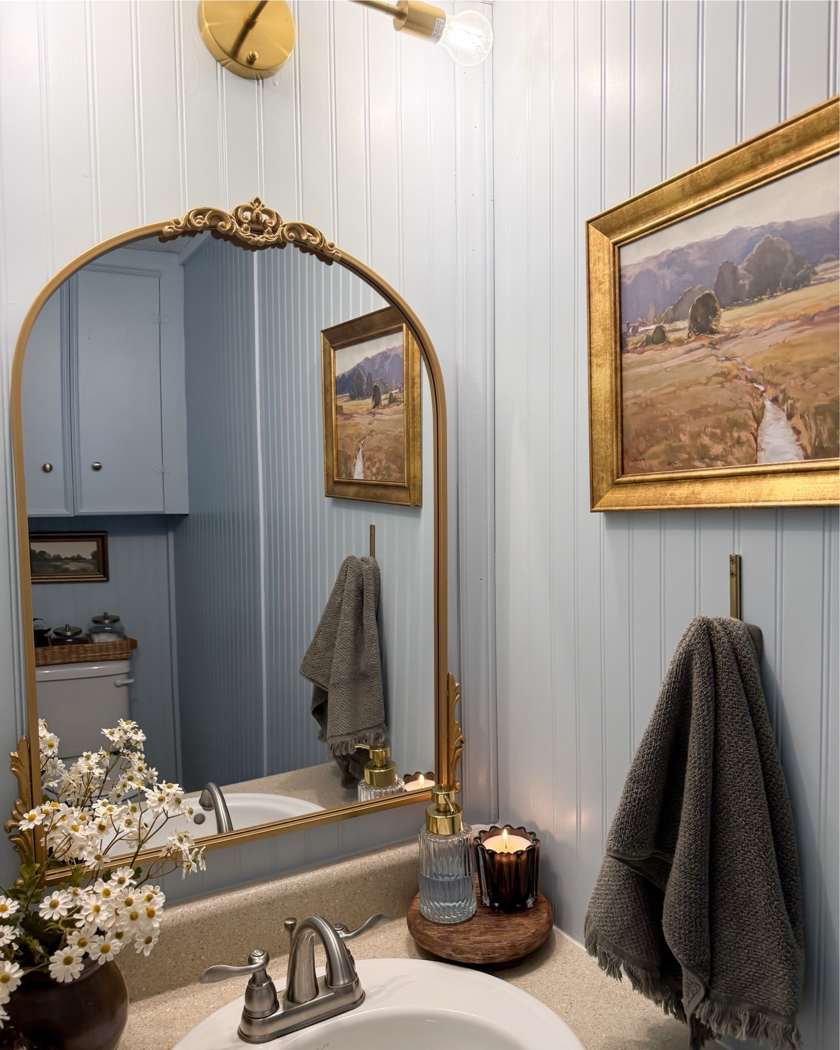 Moody powder room styling idea ✨ guess bathroom, casaluna towel, landscape art, towel hook, hand soap pump, vintage mirror, spring stems, small vase, target home decor, McGee & Co 



#LTKSeasonal #LTKSaleAlert #LTKHome