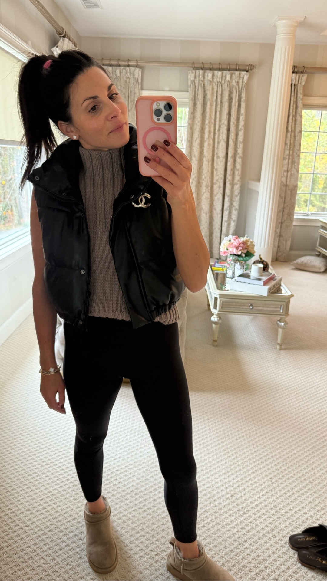 This outfit perfectly captures that “elevated mom-on-the-go” vibe — comfy enough for the school drop-off, chic enough for a meeting or errands right after. Here’s a caption you could post with your photo:

Alo Yoga is my typical mom uniform, but when I want to take the look from workout to work, I just add a few elevated layers — a chunky knit, a sleek puffer vest, and a classic Chanel pin. Cozy, pulled-together, and still totally practical. 💁🏻‍♀️
#MomStyle #AthleisureChic #OOTD #PrettyInPinkAgain #AloYoga #FallLayers #ElevatedEveryday