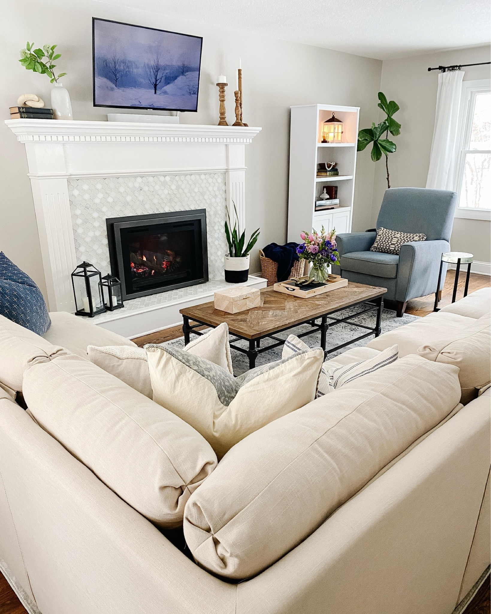 The holidays are magical, but so is the feeling of getting everything back in order! Ready to embrace a clean slate and a cozy home. 

✨ Curious on where it’s from? Shop my home by clicking on the link in my bio ✨
.
.
.
.
.
.
.
#bluechair #beigesofa #fireplacedecor #fireplace #fireplacemakeover #fireplacedesign #fireplacemantel #manteldecor #cozyfire #cozyfireplace #livingroomdecor #livingroomideas #livingroomdesign #livingroominspo #livingroomdecoration #livingroominterior #livingroomideas #livingroomstyle #winterlivingroom #winterliving #woodfloors #woodflooring #PostHolidayBliss #HomeOrganization #CleanSlate #HolidayCleanup #FreshStart #CozyVibes #HomeSweetHome #Declutter
