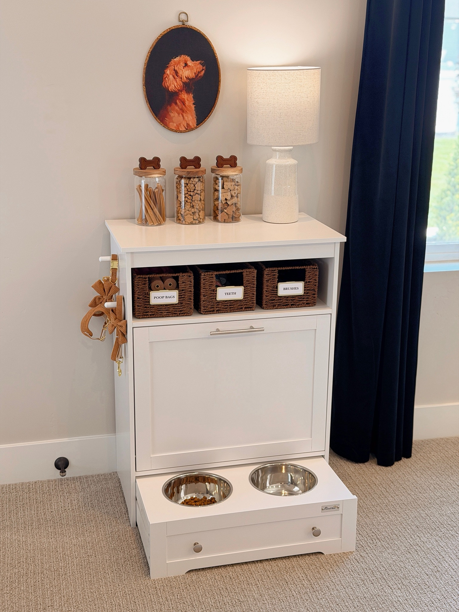 Such a smart way to keep all of your dog essentials in one spot! This organized dog feeding station has built-in food and water bowls, storage for treats, leashes, poop bags, grooming supplies and more. A functional pet organization idea that still looks beautiful in your home.

#LTKSeasonal #LTKHome