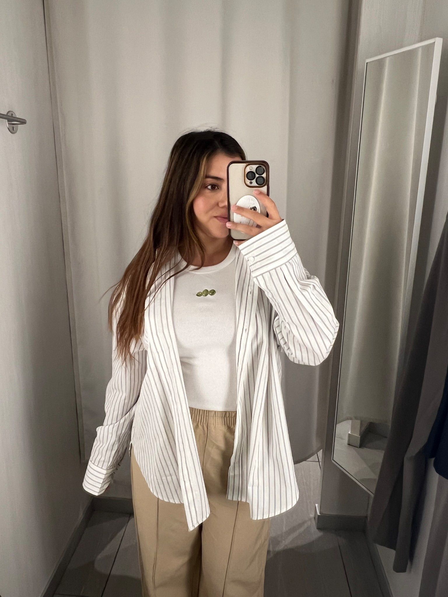 This look gives effortless chic with neutral tones that are perfect for everyday style. The striped oversized button-down layered over a fitted white tank pairs beautifully with the wide-leg beige trousers, creating that polished yet relaxed vibe. Such a versatile outfit that works for casual workwear, weekend coffee runs, or a minimalist street-style look—definitely an LTK must-have.

#LTKFallSale #LTKSeasonal #LTKStyleTip
