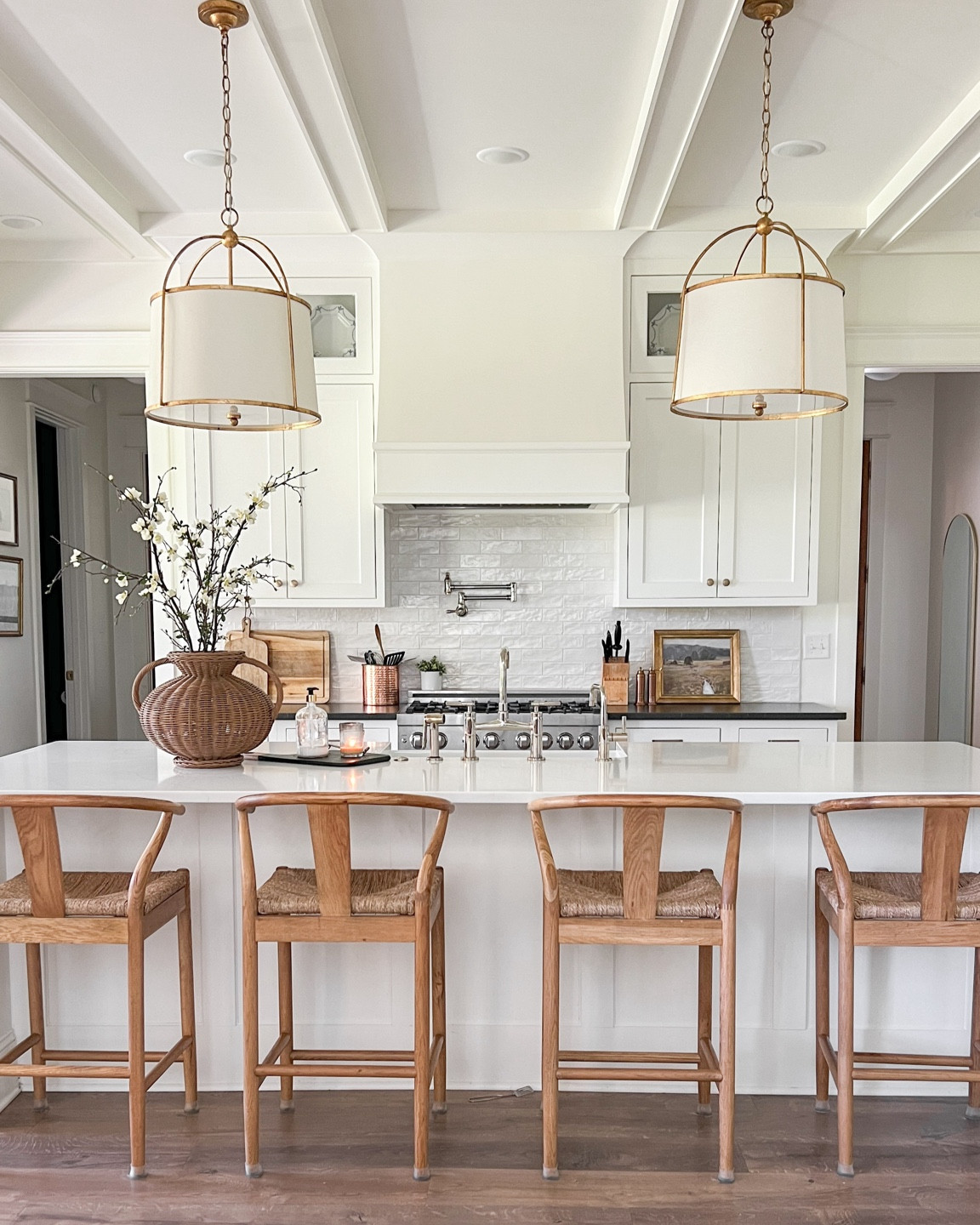 I love this view of the kitchen 🤍 

Classic white kitchen | timeless transitional kitchen | white kitchen | drum pendants, woven bar stools | white cabinets 

#LTKHome