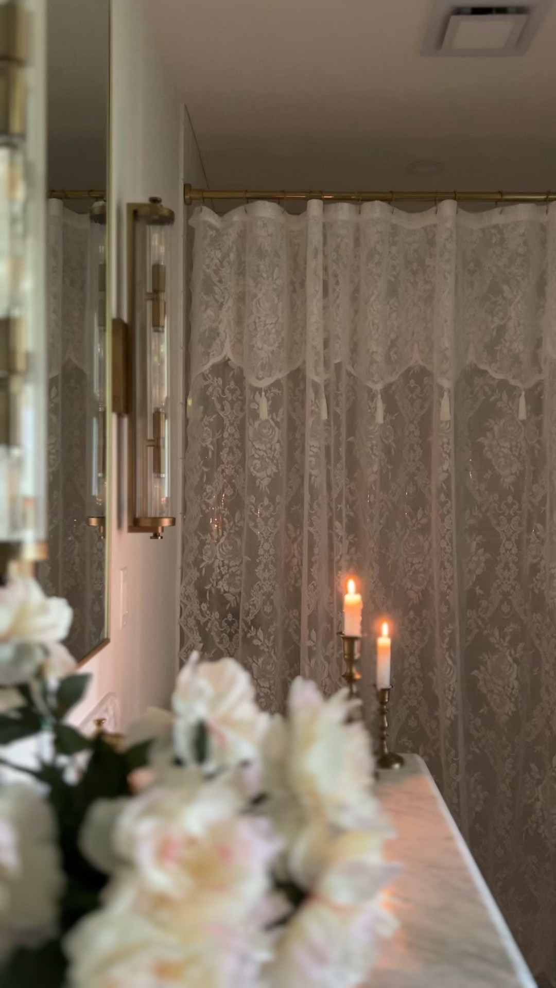 Moody fall bathroom decor doubles as the perfect self care space — lace shower curtains, glowing candles, faux flowers, and a gold mirror with sconces create that spa-like vibe at home. 

This vintage-inspired bathroom styling feels romantic and calm, turning even a small bathroom into a retreat. If you’re looking for fall bathroom ideas, cozy home inspiration, or seasonal decorating that makes self care feel special, these warm gold accents and soft candlelight bring it all together. 

Everything from the lace curtains to the faux florals and bathroom mirror is linked so you can create your own self care sanctuary.

#LTKSeasonal #LTKSaleAlert #LTKHome