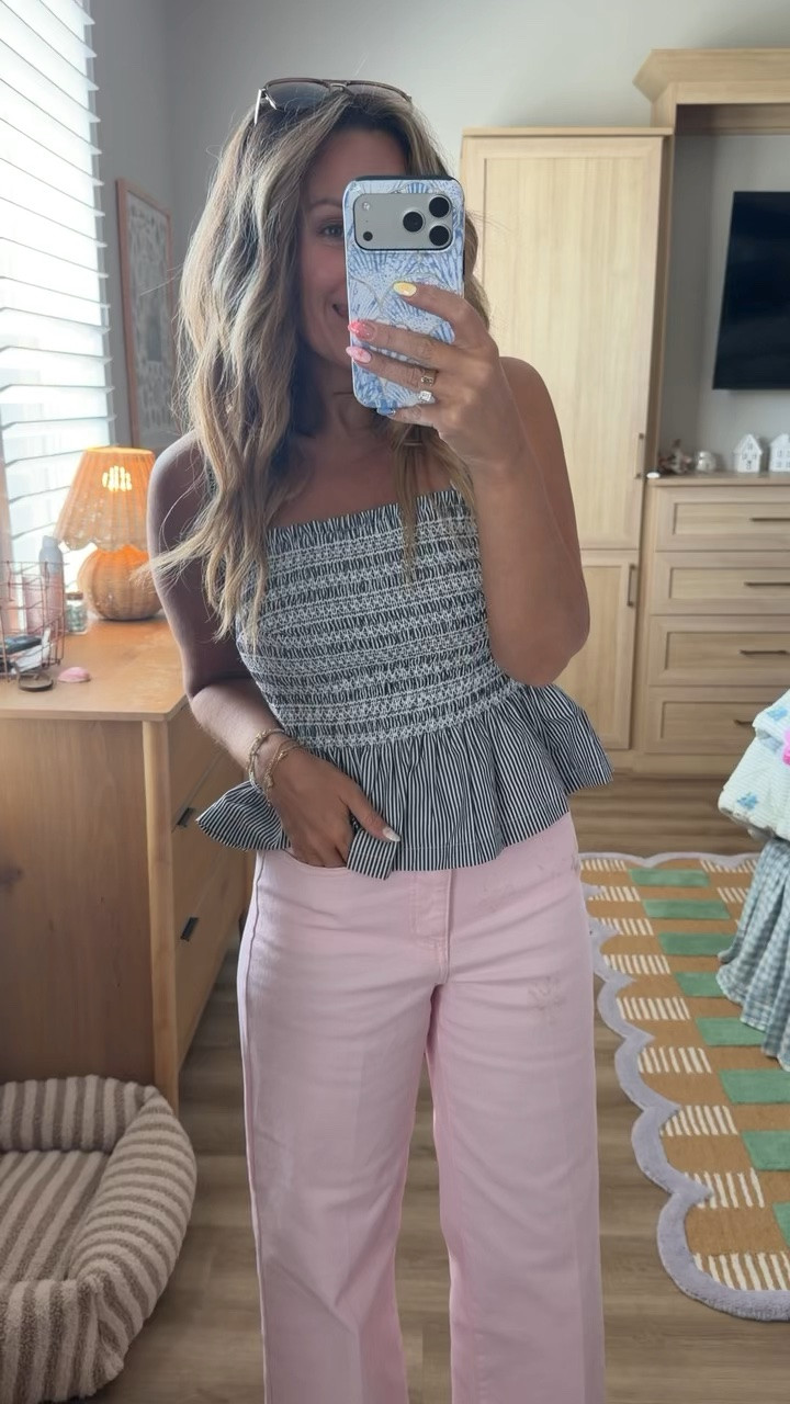This smocked peplum tank is so flattering and lightweight, and I love it paired with these pink wide-leg jeans for a fun pop of color. Such an easy outfit for brunch, vacation, shopping, or any casual summer day. Finished it off with my favorite everyday sandals and simple accessories

summer outfit, pink jeans, wide leg jeans, smocked tank, peplum top, striped tank, casual summer style, vacation outfit, brunch outfit, petite fashion, everyday outfit, neutral sandals, coastal style, affordable fashion.