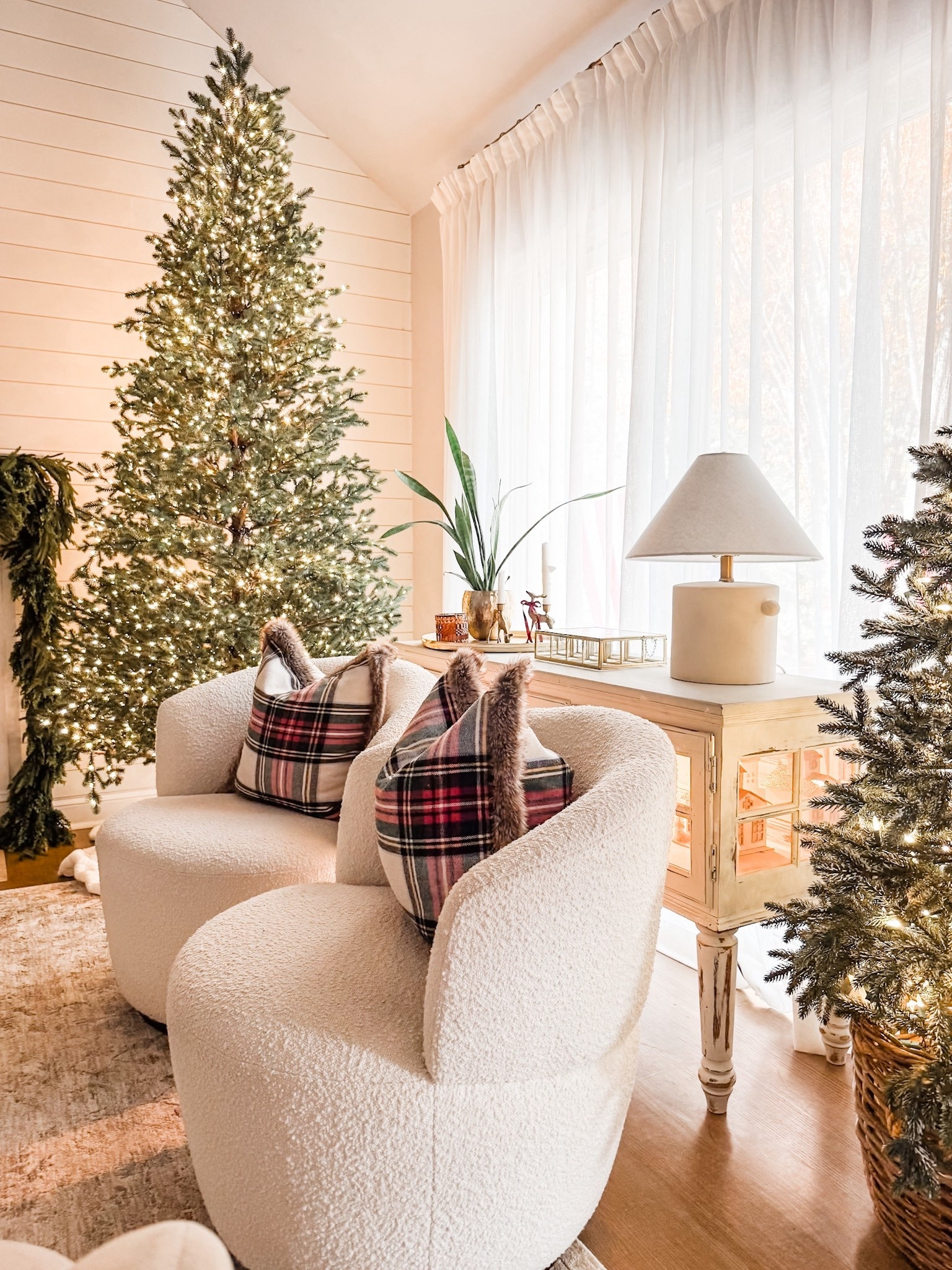 Artificial Christmas tree
Home Depot Elegant Grand Fir 9 ft. Christmas Tree
Bouclè swivel chairs 
Holiday throw pillow
Studio McGee ceramic table lamp 
Pinch pleat curtains
Faux linen pinch pleat drapes
Amazon drapes
Gold curtain rod 
Curtain drapery rings
Christmas decor
Living room decor
Holiday decor 
Neutral area rug
Cedar garland 
Norfolk pine garland 

#LTKHoliday #LTKSeasonal #LTKHome