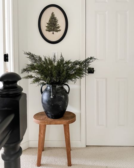 Easy little holiday corner idea: stool, vase, stems, art. Foolproof! 4 cedar branches seen here. 

#LTKstyletip #LTKhome #LTKHoliday
