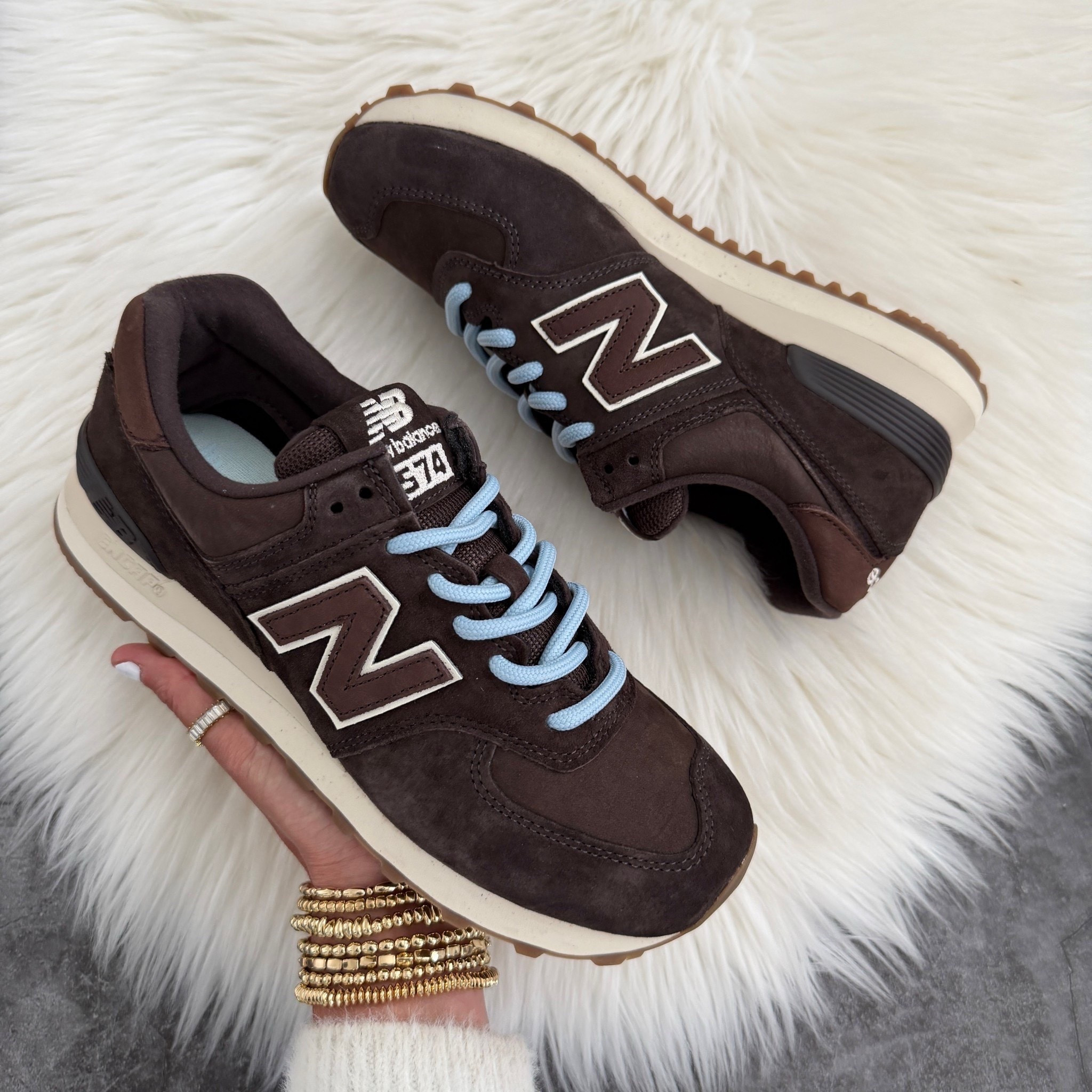 New balance 574 sneakers runs true to size. The sneakers also include brown laces Color: black coffee with angora