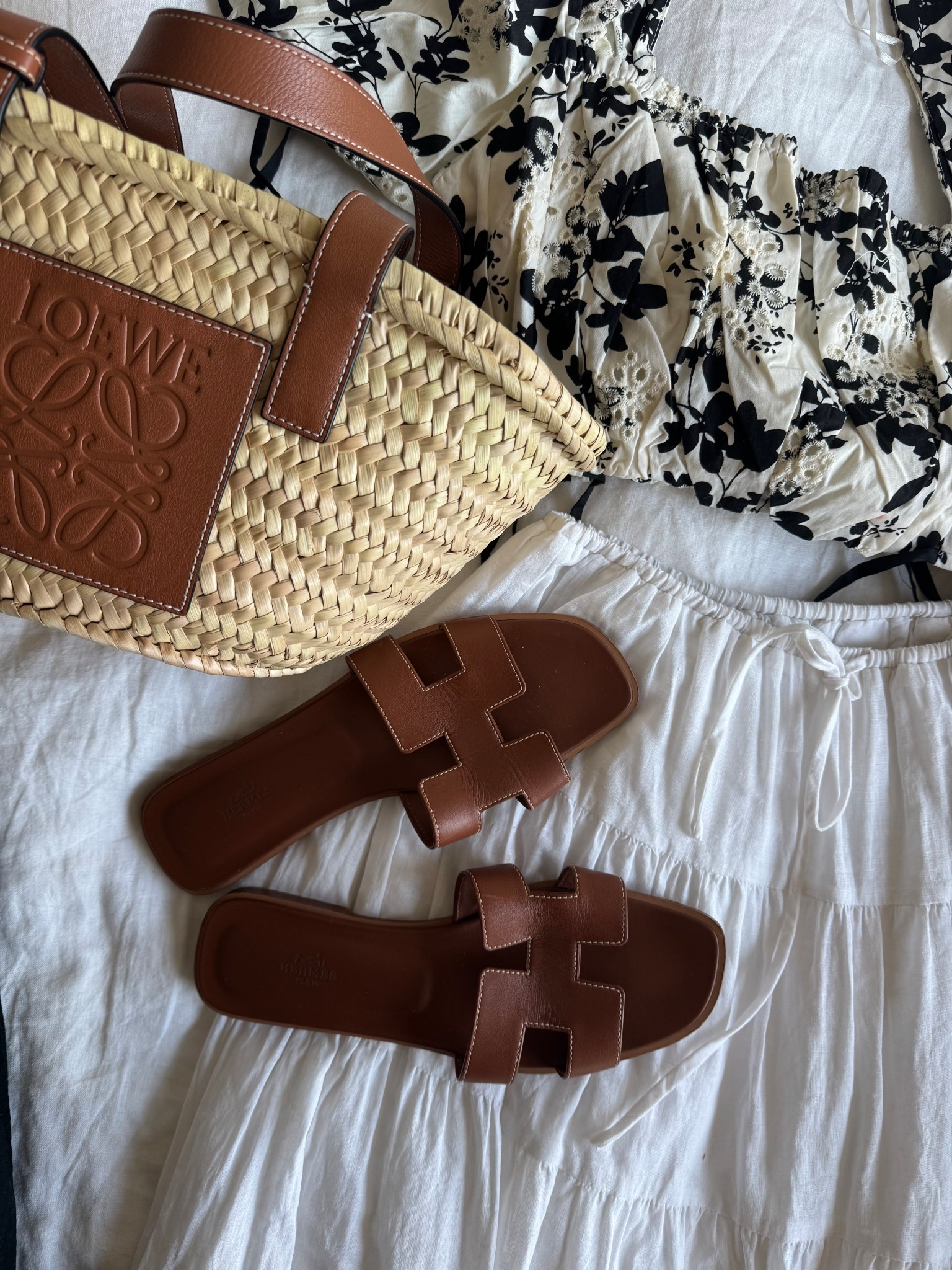 Vacation outfit flatlay ☀️ I love incorporating some color for beach looks, but I love my neutrals too! A mix of materials (straw, cotton, leather) keep the outfit interesting. A flowy maxi skirt and straw bag is a must for every warm weather trip, I think!

#LTKTravel #LTKSeasonal