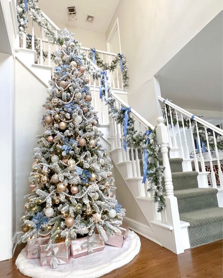 Skinny 8’ flocked Pink & Blue Grandmillennial Christmas Tree. Added blue poinsettia flowers, shiny pastel ornaments, and strands of pearl garland to my Christmas tree. For the stairs I used  my favorite garlands, and added some mini ornaments, French blue ribbon, and zip tied them to the railings. Holiday decor, Christmas decorations, preppy, feminine, coastal, pastel  

#LTKparties #LTKhome #LTKHoliday