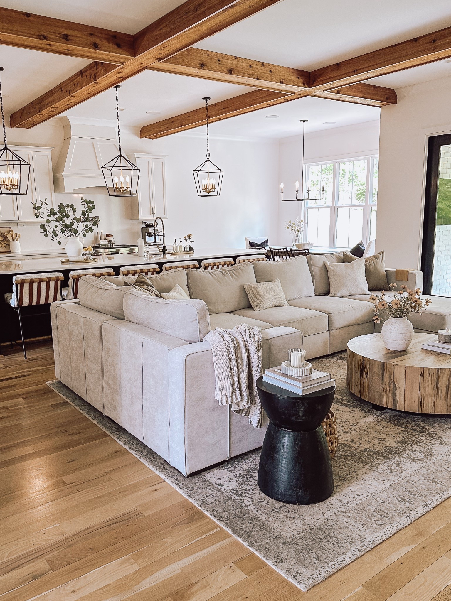 Living room,  neutral living room, sectional, black accent table, round wood coffee table, upholstered barstools, modern rustic home

#LTKHome