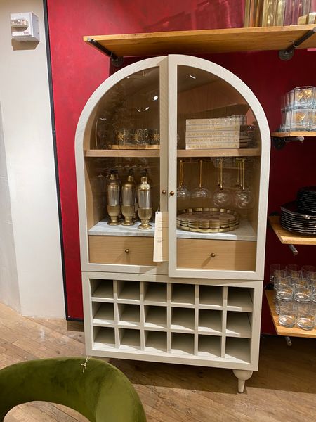 Obsessed with this white Fern Bar Cabinet from Anthropologie. It has so much storage for my bar decor. Arch cabinets are trending in home decor  

#LTKstyletip #LTKover40 #LTKhome