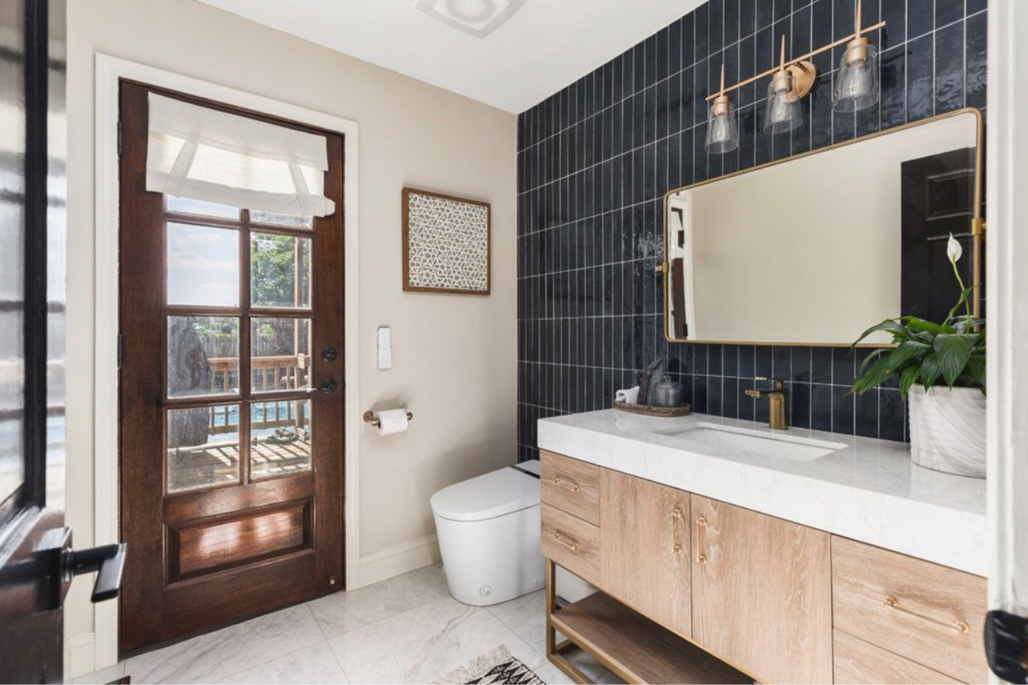 Absolutely love this pool bathroom. 

The blue vertical tiled wall, the white tile floor. The vanity is beautiful! 

#LTKU #LTKHome #LTKSeasonal