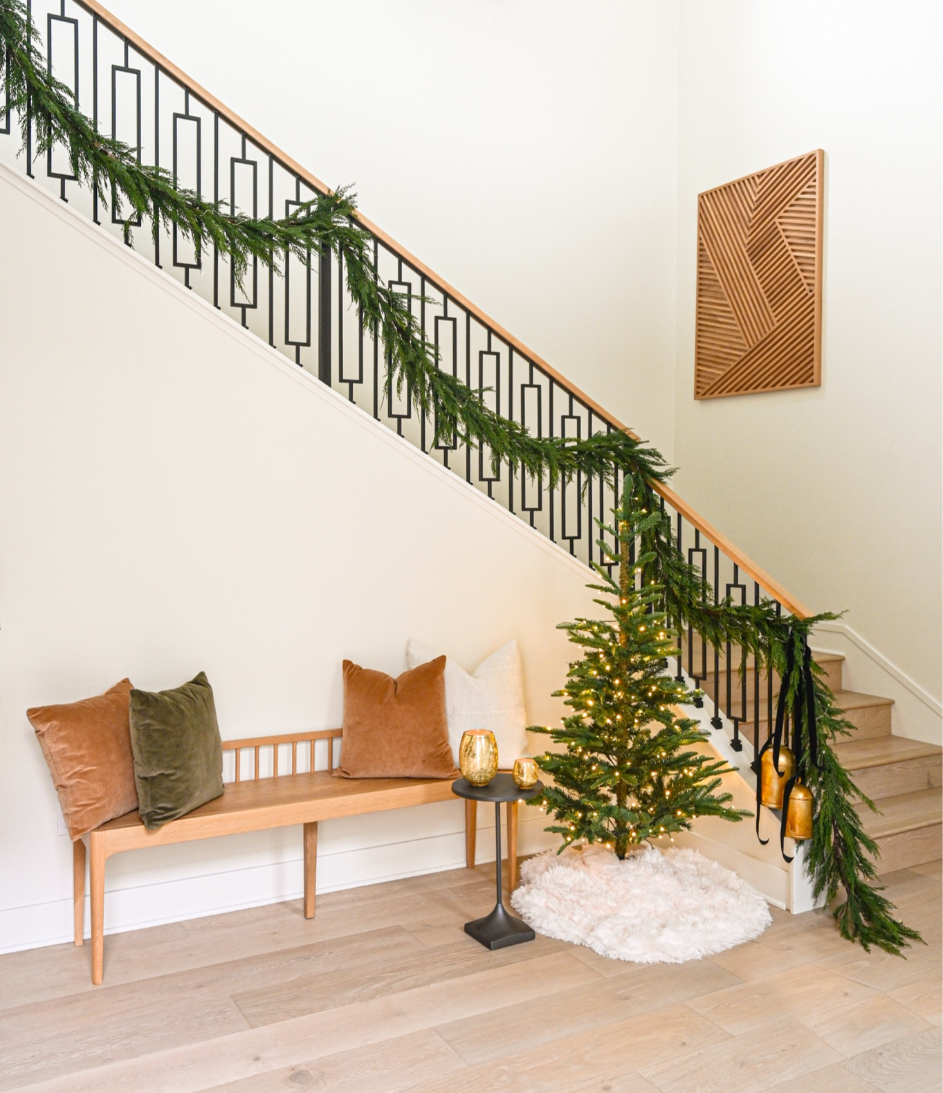 Christmas staircase and entryway draped in faux garland with a small Christmas tree and lots of fairy lights makes for a very festive welcome.

#LTKHoliday #LTKhome #LTKSeasonal