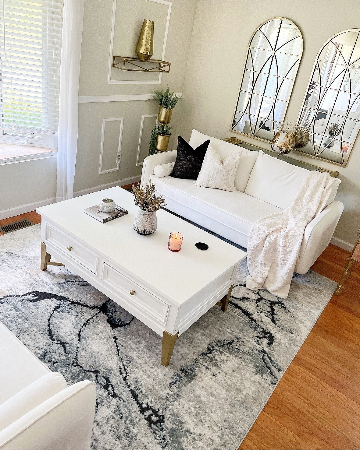 Save 79% off my abstract living room rug! Living room inspo on a budget! White sofa | white coffee table | gold arch mirror | gold home accents | neutral throw pillows | throw blanket | abstract rug 
@wayfair #wayfairhomefinds 


#LTKFindsUnder100 #LTKSaleAlert #LTKHome