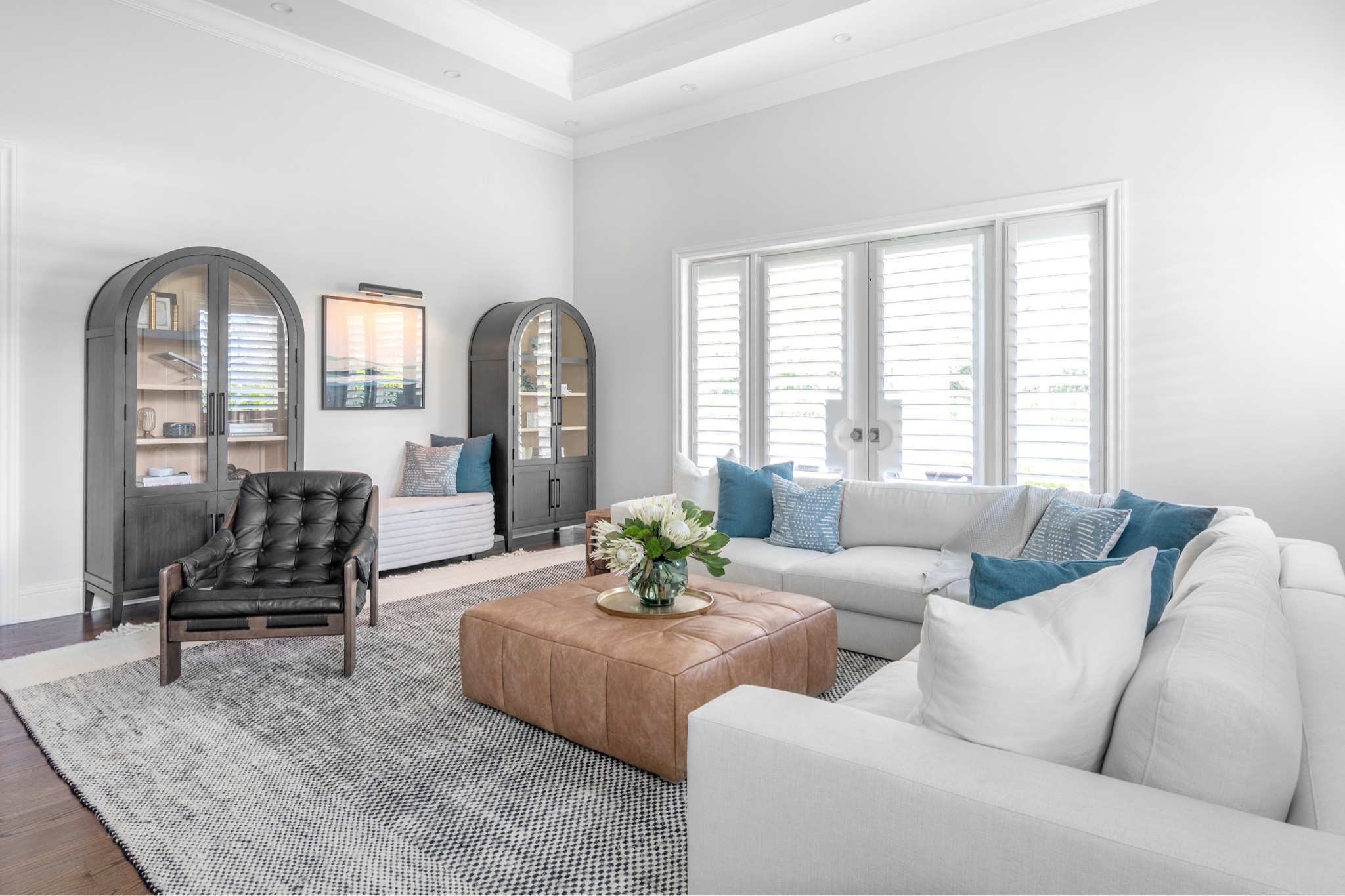 The family room, designed for comfort and practicality, features an off-white sectional treated with Scotchgard for durability and a deep blue shiplap focal wall. With upgraded IKEA bookcases for toy storage and a family portrait gallery, the space blends style and function, making it both inviting and kid-friendly.


#LTKFamily #LTKHome